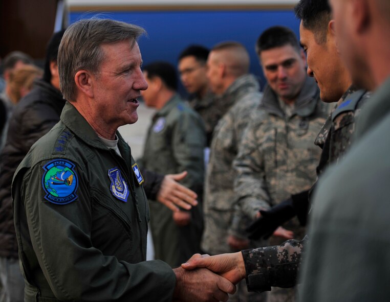 Gen. Hawk Carlisle, Pacific Air Forces commander, greets a Republic of Korea air force member upon his arrival to Osan Air Base, Republic of Korea, Jan. 21, 2014. Carlisle visited Osan to get a first-hand look at how Airmen from across the base accomplish the mission. (U.S. Air Force photo/Senior Airman Siuta B. Ika)