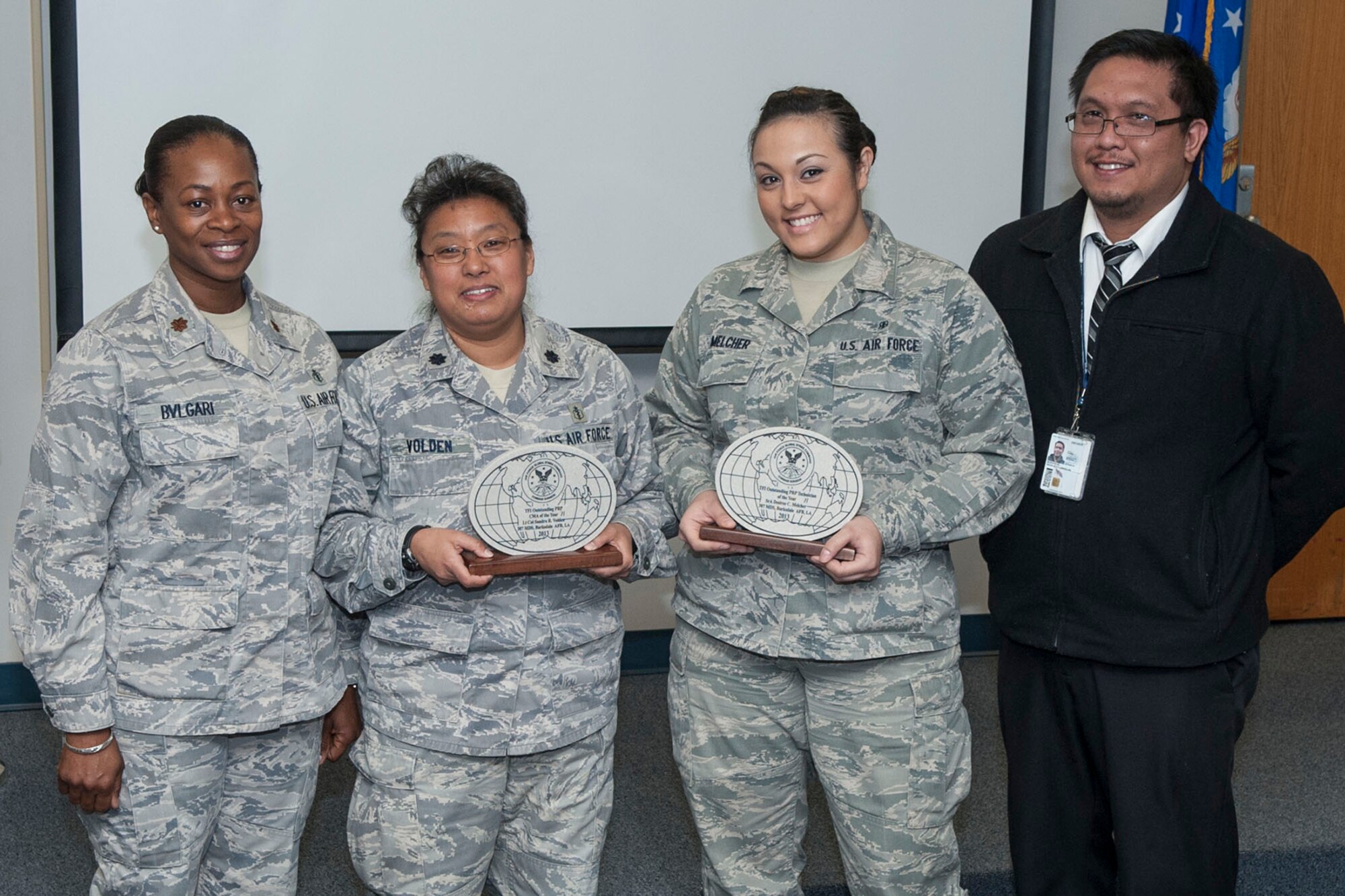 U.S. Air Force Maj. Jacqueline Bvlgari, competent medical authority (CMA), Air Force Global Strike Command (AFGSC), Lt. Col. Sandra Volden, lead competent medical authority, 307th Medical Squadron (MDS), Senior Airman Desiree Melcher, Reserve Medical Unit Personnel Reliability Program (PRP) monitor, 307 MDS, and Reginald Buenviaje, civilian PRP monitor, AFGSC, pose for a photo during the 307 MDS Commander’s Call at Barksdale Air Force Base, La., Jan. 26, 2014. Volden and Melcher were presented with the Air Force Global Strike Command, Command Surgeon, Total Force Integration (TFI) Outstanding PRP CMA of the Year and TFI Outstanding PRP Technician of the Year awards. (U.S. Air Force photo by Master Sgt. Jeff Walston)  