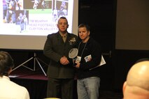 Capt. Matthew Lamb, executive officer, RS Indianapolis, shakes the hand of Semper Fidelis Coach award winner Scott Widner, head football coach, Shenandoah High School, Middletown, IN, at the 2014 Glazier Coaches Clinics in Indianapolis Jan. 25. Coach Widner received the award for building a consistently winning football program and being an outstanding role model for his players.