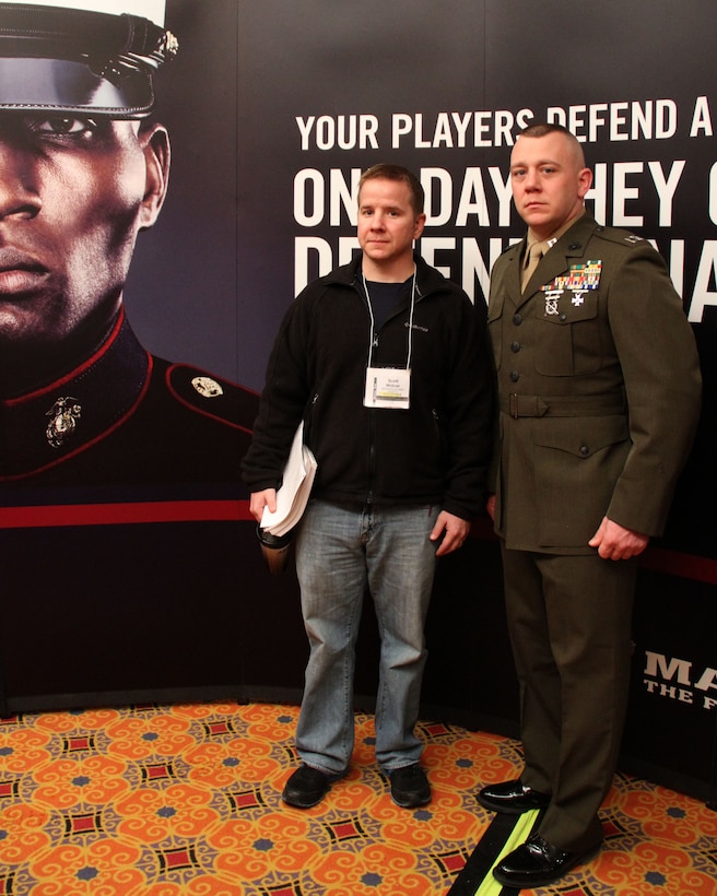 Capt. Matthew Lamb, executive officer, RS Indianapolis, stands with the winner of Semper Fidelis Coach award Scott Widner, head football coach, Shenandoah High School, Middletown, IN, in front of the Marine booth at the 2014 Glazier Coaches Clinics in Indianapolis Jan. 25. Coach Widner received the award for building a consistently winning football program and being an outstanding role model for his players.