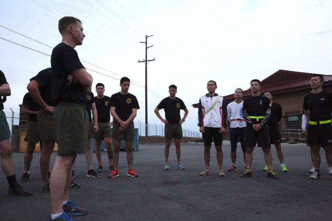 U.S. Marines from 1st Air Naval Gunfire Liaison Company and soldiers from the Japan Ground Self-Defense Force circle up after physical training during Exercise Iron Fist 2014 aboard Camp Pendleton, Calif., Jan. 24, 2014. Iron Fist 2014 is an amphibious exercise that brings together Marines and sailors from the 15th Marine Expeditionary Unit, other I Marine Expeditionary Force units, and soldiers from the JGSDF, to promote military interoperability and hone individual and small-unit skills through challenging, complex and realistic training. (U.S. Marine Corps photo by Lance Cpl. Anna K. Albrecht/Released)