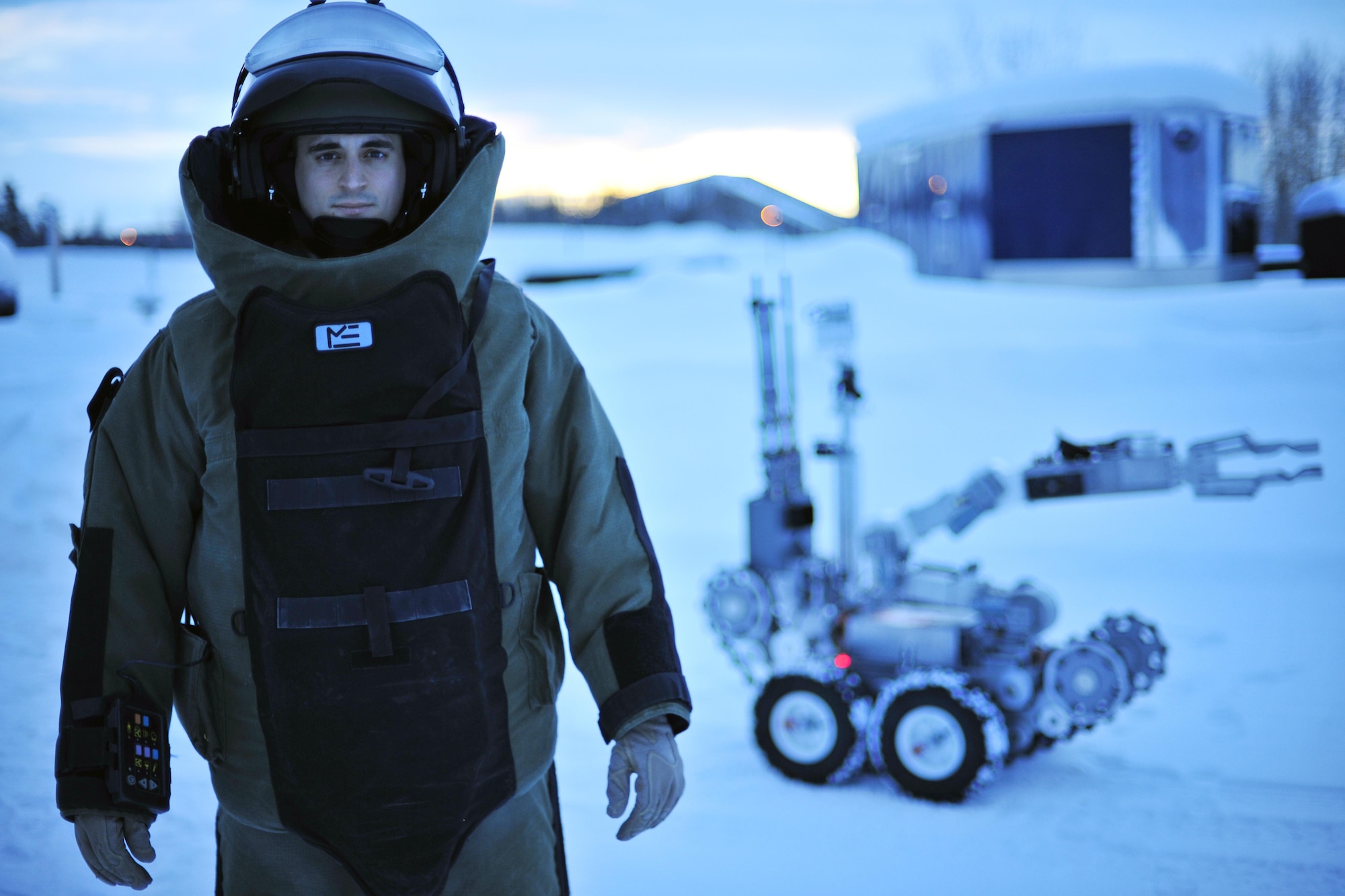 Staff Sgt. Joseph Riemer stands by an F6A robot in an explosive ordnance disposal bomb suit Jan. 21, 2014, at Eielson Air Force Base, Alaska.  Reimer works as an EOD disposal technician with the 354th Civil Engineer Squadron. (U.S. Air Force photo/Staff Sgt. Jim Araos)