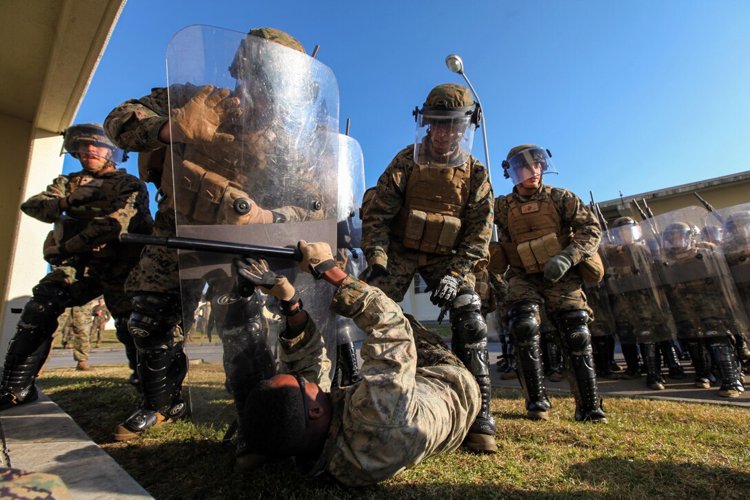 Marines of the riot control team for Golf Battery, Battalion Landing Team 2nd Battalion, 5th Marines, 31st Marine Expeditionary Unit, attempt to subdue a role player wielding a weapon during the culminating event of the unit’s public disorder and non-lethal weapons employment training here, Jan. 24. One of the secondary missions of Golf Battery is to serve as a non-lethal contingency force for the 31st MEU, useful in embassy security reinforcement, humanitarian operations and many other contingencies. The 31st MEU is the Marine Corps’ force in readiness for the Asia-Pacific region and the only continuously forward-deployed MEU.


