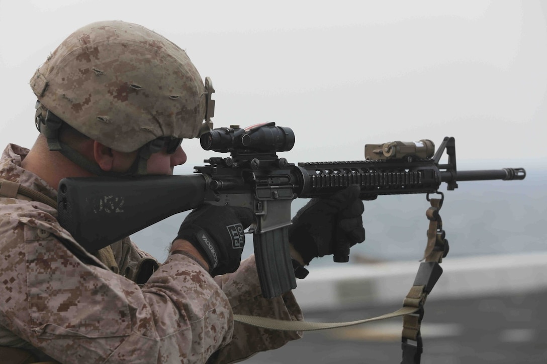 ARABIAN GULF (Jan. 24, 2014) – A U.S. Marine assigned to Battalion Landing Team 1/4, 13th Marine Expeditionary Unit, conducts a deck shoot aimed at moving targets aboard USS New Orleans (LPD 18), Jan. 24, 2014.  This training event, using a target system designed by Combat Engineers attached to the unit, is the first-ever live-fire shoot involving moving targets on an amphibious ship. The 13th MEU is deployed with the Boxer Amphibious Ready Group as a theater reserve and crisis response force throughout the U.S. 5th Fleet area of responsibility. (U.S. Marine Corps photo by Cpl. David Gonzalez 13th Marine Expeditionary Unit Combat Camera/Released)