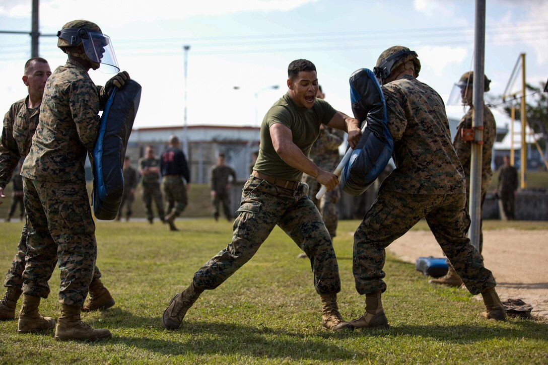 Corporal Joshua L. Donald, a training non-commissioned officer with Golf Battery, Battalion Landing Team 2nd Battalion, 5th Marines, 31st Marine Expeditionary Unit, and a native of Orlando, Fla., strikes at multiple opponents of a “fight through” course after being exposed to oleoresin capsicum (a more potent form of pepper spray) during the culminating event of the unit’s public disorder and non-lethal weapons employment training here, Jan. 24. Experiencing OC spray ensures Marines understand the effects and, if cross-contaminated during use, they are able to fight through the pain and perform their job. One of the secondary missions of Golf Battery is to serve as a non-lethal contingency force for the 31st MEU, useful in embassy security reinforcement, humanitarian operations and many other contingencies. The 31st MEU is the Marine Corps’ force in readiness for the Asia-Pacific region and the only continuously forward-deployed MEU.


