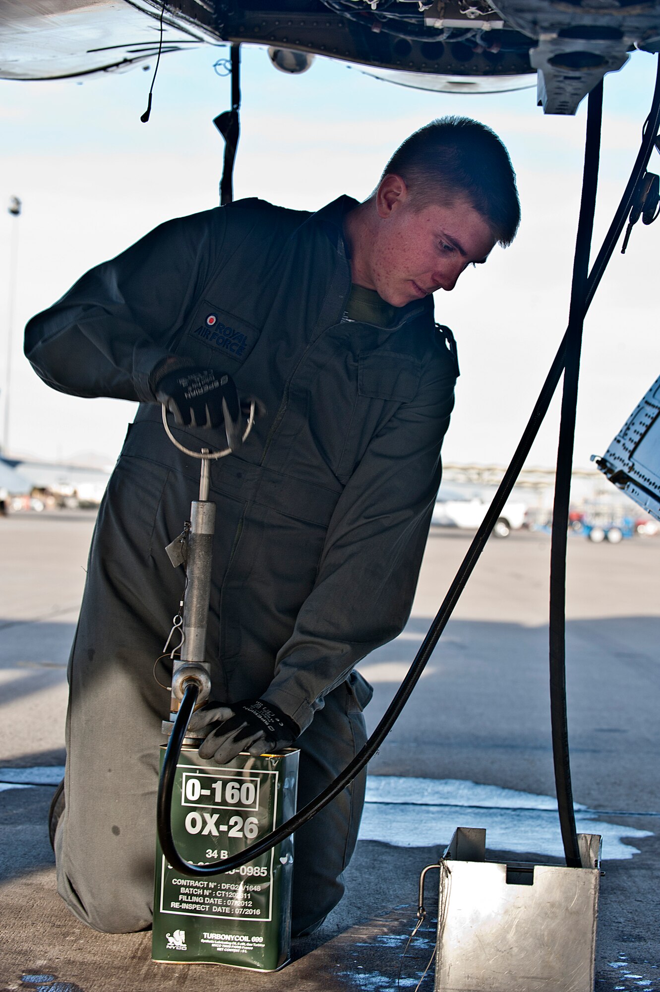 Royal Air Force Senior Air Craftsman Josh Dales, IX (B) Squadron aircraft maintenance mechanic, from RAF Marham, United Kingdom, drains the old oil from a GR4 Tornado during Red Flag 14-1 Jan. 27, 2014, at Nellis Air Force Base, Nev. Red Flag is one of a series of advanced training programs administered by the United States Air Force Warfare Center and Nellis, and executed through the 414th Combat Training Squadron. (U.S. Air Force photo by Senior Airman Matthew Lancaster)