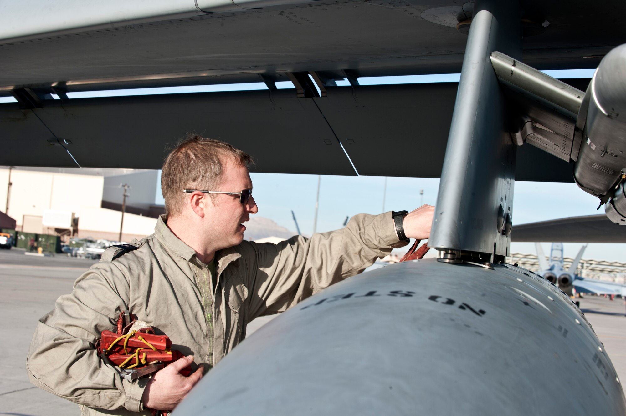 Royal Air Force Corporal Steve Pascoe, IX (B) Squadron mechanical engineer, from RAF Marham, United Kingdom, pins inspection marker flags onto a GR4 Tornado during Red Flag 14-1 Jan. 27, 2014, at Nellis Air Force Base, Nev. Red Flag expanded to incorporate all spectrums of warfare to include command and control, real-time intelligence, analysis and exploitation, and electronic warfare. (U.S. Air Force photo by Senior Airman Matthew Lancaster)