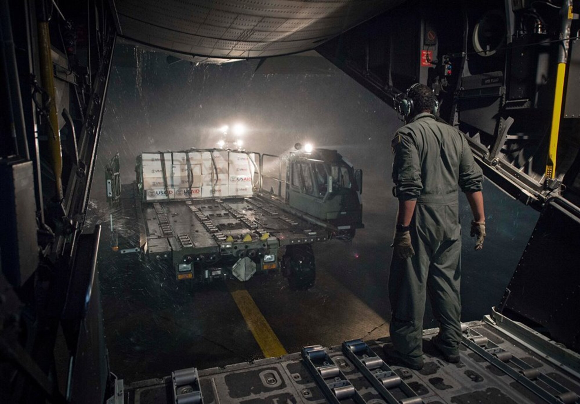 Staff Sgt. Mike Jones, assigned to 1st Special Operation Squadron (1 SOS), directs a forklift of supplies off an MC-130 Combat Talon II from the U.S. Agency for International Development as part of Operation Damayan Nov. 20. The Philippine government is closely coordinating ongoing relief efforts including search and rescue, supply drops and personnel airlifts with military and civilian organizations. (U.S. Navy photo by Mass Communication Specialist 2nd Class Daniel M. Young/Released)




