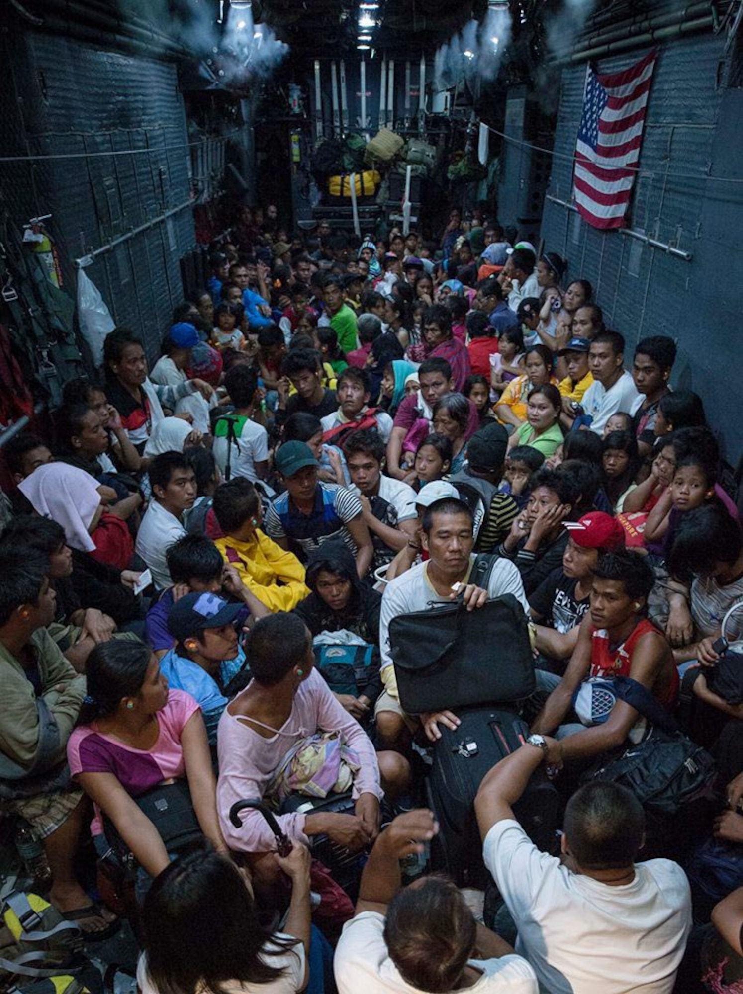 Families in Ormoc affected by Typhoon Haiyan board an MC-130 Combat Talon II from 1st Special Operation Squadron (1 SOS), Nov. 20 to be transported to Manila as part of Operation Damayan. The Philippine government is closely coordinating ongoing relief efforts including search and rescue, supply drops and personnel airlifts with military and civilian organizations. (U.S. Navy photo by Mass Communication Specialist 2nd Class Daniel M. Young/Released)



