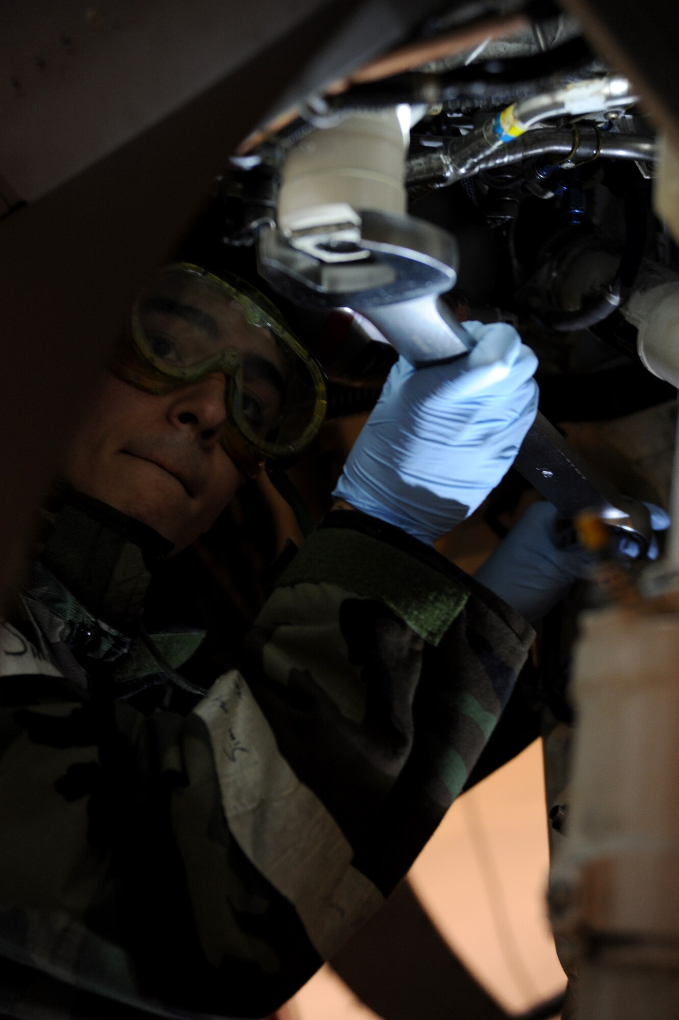 U.S. Air Force Airman 1st Class Ryan Scavuzzo, 35th Maintenance Squadron crew chief/phase inspection section team member, tightens a hydraulic filter on an F-16 Fighting Falcon during an operational readiness exercise Jan. 27, 2014. Scavuzzo's job as a phase inspector mandates that he pays close attention to detail while executing an in-depth inspection of the jet. (U.S. Air Force photo/Tech. Sgt. April Quintanilla)