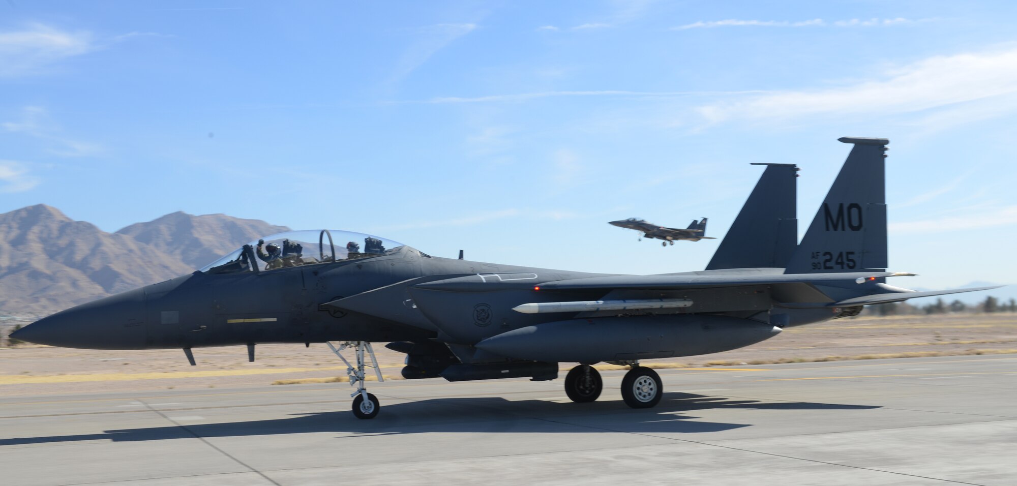 An F-15E Strike Eagle pilot cheers while going along the flightline as another F-15 comes in for a landing Jan 26, 2014, at Nellis ir Force Base, Nev. The 391st Fighter Squadron is at Nellis to participate in Red Flag 14-1 Jan. 27 to Feb. 14. (U.S. Air Force photo by Senior Airman Benjamin Sutton/Released)