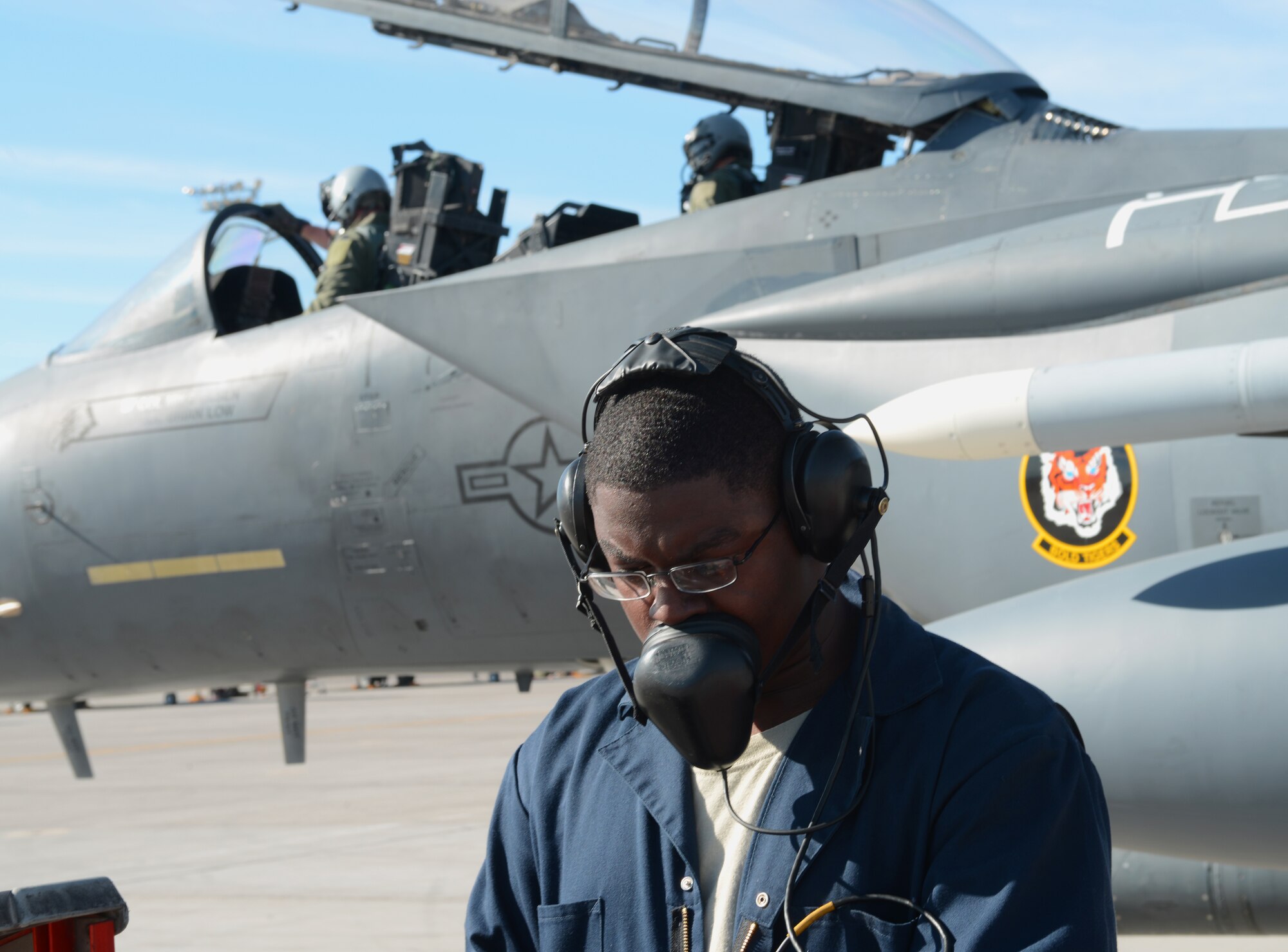 Staff Sgt. Tyrin Rush, 366th Aircraft Maintenance Squadron crew cheif, inspects his technical manual checklist Jan 26, 2014, at Nellis ir Force Base, Nev. Rush is participating in Red Flag along with more than 100 personnel from Mountain Home Air Force Base, Idaho. (U.S. Air Force photo by Senior Airman Benjamin Sutton/Released)