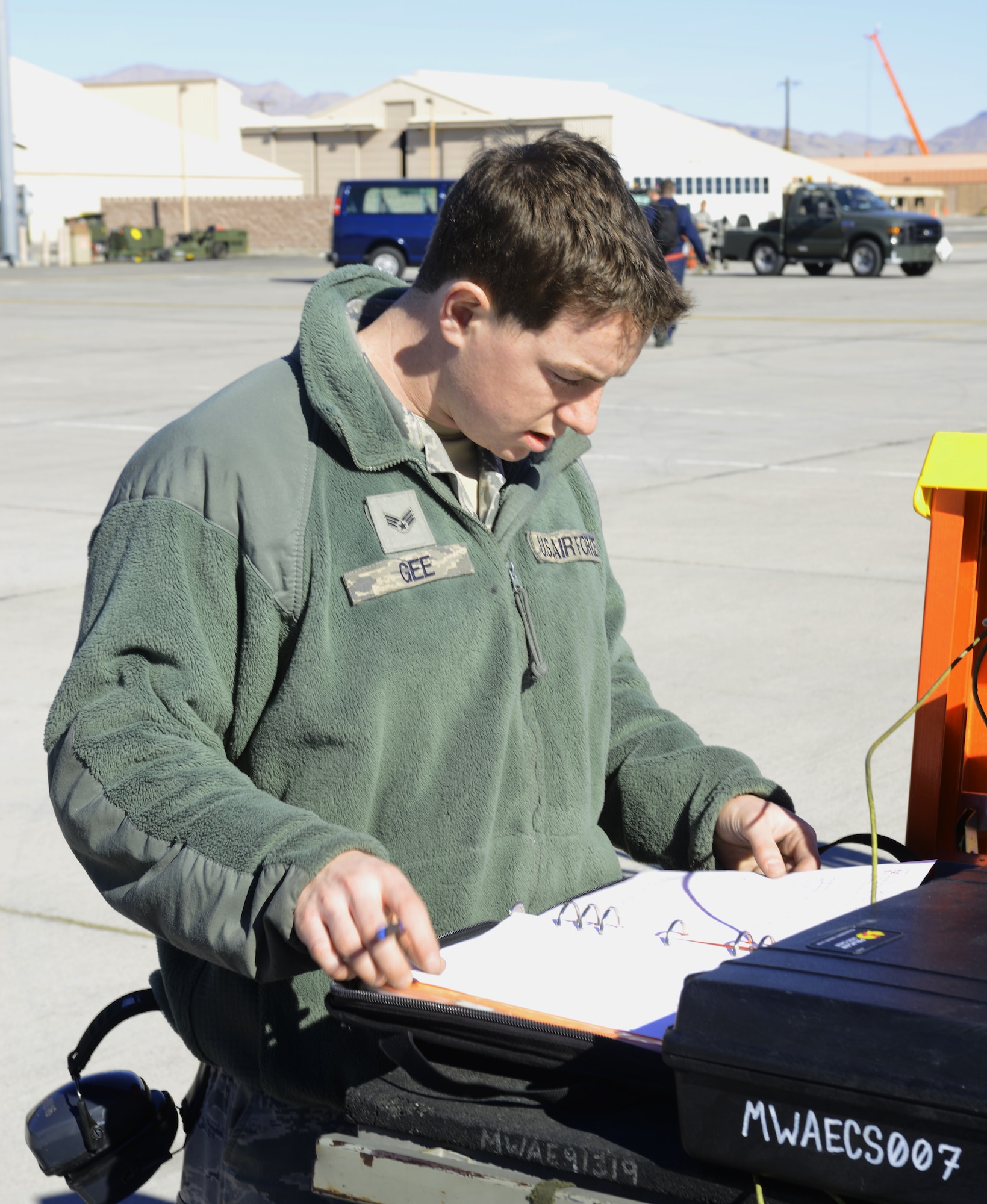 Senior Airman Jordan Gee, 366th Aircraft Maintenance Squadron weapons journeyman, goes through technical notes before a flight Jan 27, 2014, at Nellis Air Force Base, Nev. Gee is one of more than 3,200 participants in the combat exercise Red Flag 14-1. The purpose of the exercise is to increase the combat capability of U.S. and allied air forces for future combat situations. (U.S. Air Force photo by Senior Airman Benjamin Sutton/Released)