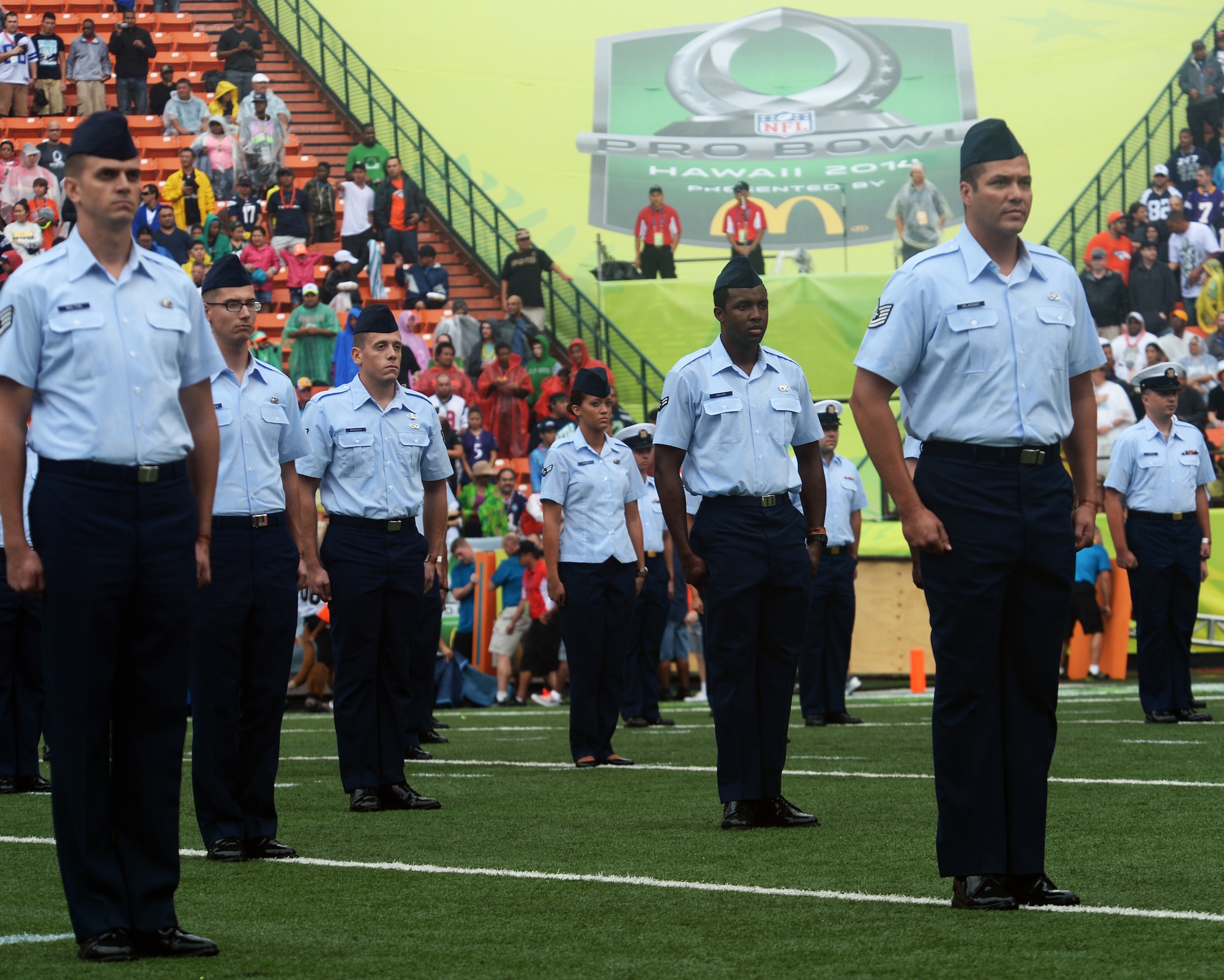 U.S. Air Force Airmen stand at attention during the Presentation of Colors and singing of The Star-Spangled Banner at the 2014 Pro Bowl at Aloha Stadium in Honolulu, Hawaii, Jan. 26, 2014. Hundreds of service members from the U.S. Air Force, Army, Marine Corps and Navy lined up in formation on the field to participate in the national anthem presentation. (U.S. Air Force photo/Staff Sgt. Alexander Martinez)