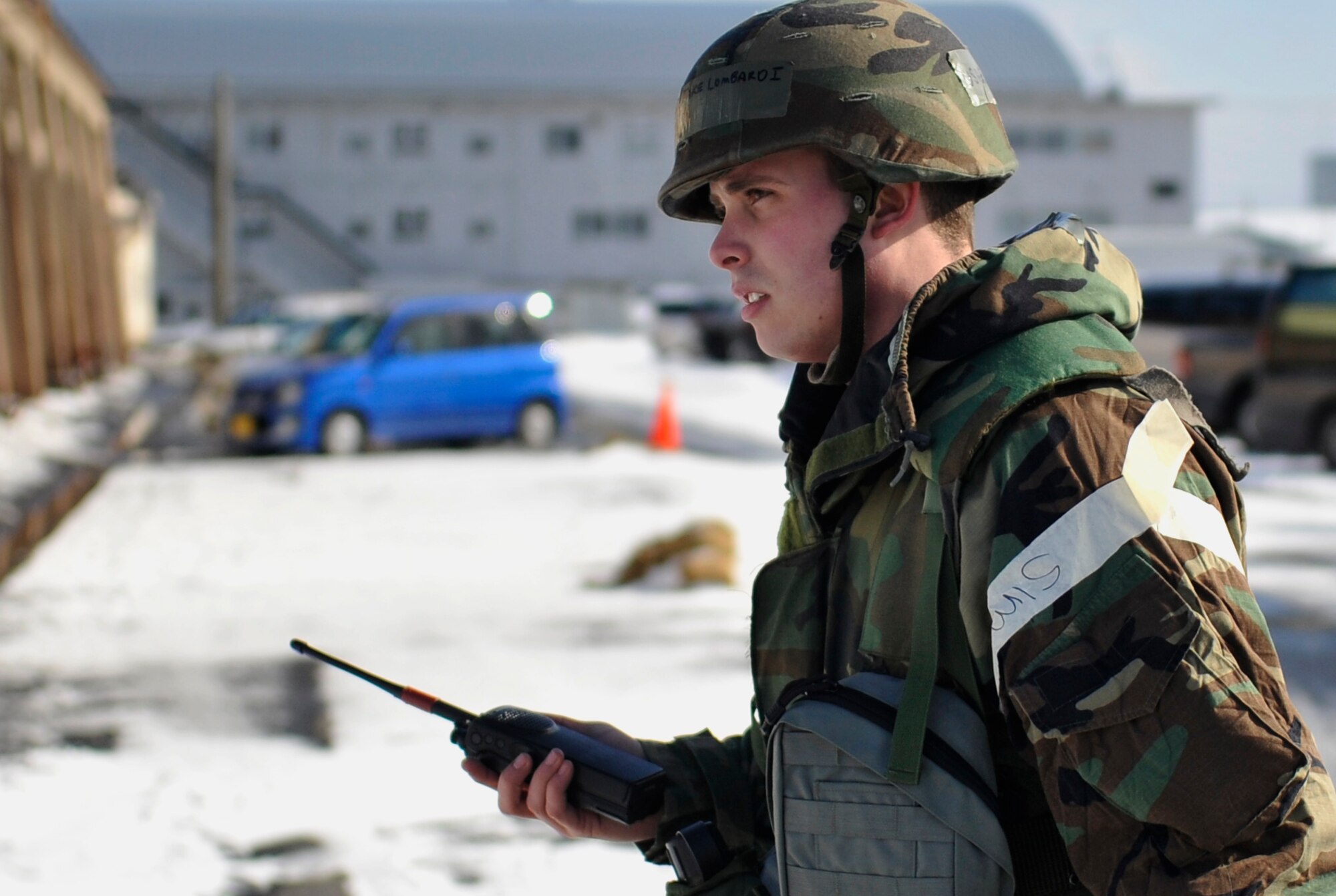 Airman 1st Class Jake Lombardi, 35th Fighter Wing public affairs broadcast journalist, radios in the results of a post attack reconnaissance sweep during an operational readiness exercise at Misawa Air Base, Japan, Jan. 27, 2014. During Phase II of the ORE, Airmen are tested on their ability to perform the mission during simulated contingency operations. (U.S. Air Force photo by Airman 1st Class Zachary Kee)