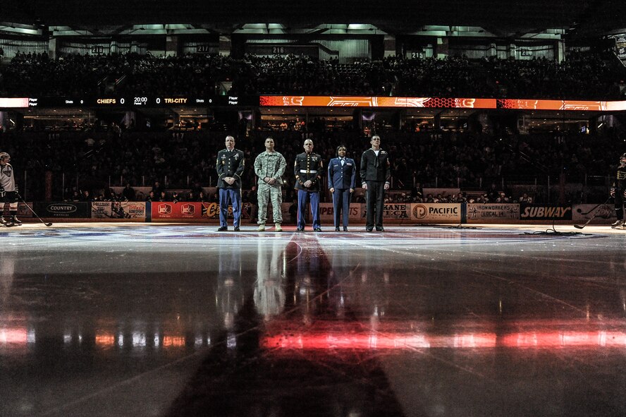 United States Armed Forces members greet the attending audience during the opening ceremonies at the Spokane Chiefs Military Appreciation Night Jan. 26, at Spokane, Wash.  The Spokane Chiefs hosted the Tri-City Americans at Spokane Arena as part of their Military Appreciation Night to honor members of the U.S. Armed Forces and thanked them for their service. (U.S. Air Force photo by Staff Sgt. Alexandre Montes/RELEASED)