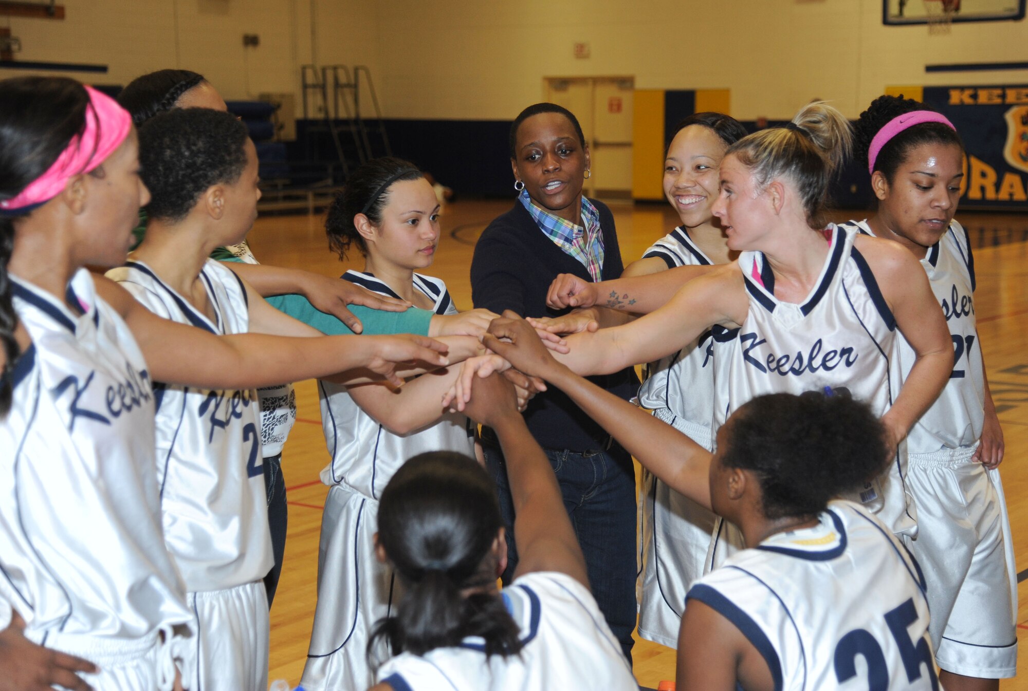Karen Moore, Keesler assistant coach, pulls the team together during a timeout during a women’s varsity basketball game against Fort Gordon Jan. 25, 2014, Keesler Air Force Base, Miss. Keesler defeated Fort Gordon, 70-37. The men’s team lost to Fort Gordon, 78-88.  (U.S. Air Force photo by Kemberly Groue)
