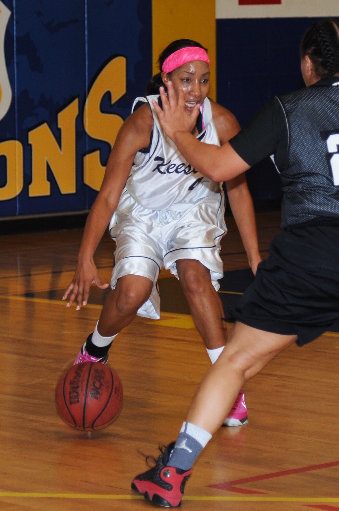 Tomeika Frazier, Keesler, dribbles the ball towards a defensive player from Fort Gordon during a women’s varsity basketball game Jan. 25, 2014, Keesler Air Force Base, Miss. Keesler defeated Fort Gordon, 70-37. The men’s team lost to Fort Gordon, 78-88. (U.S. Air Force photo by Kemberly Groue)