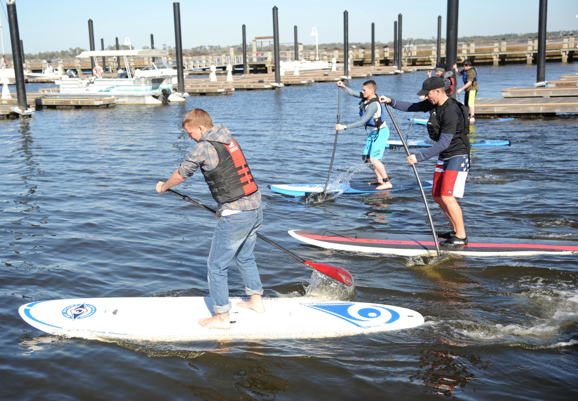 The paddle board participants begin the race during the 2nd annual polar bear regatta Jan. 25, 2014, at Marina Park, Keesler Air Force Base, Miss.  The event was sponsored by outdoor recreation.  (U.S. Air Force photo by Kemberly Groue)