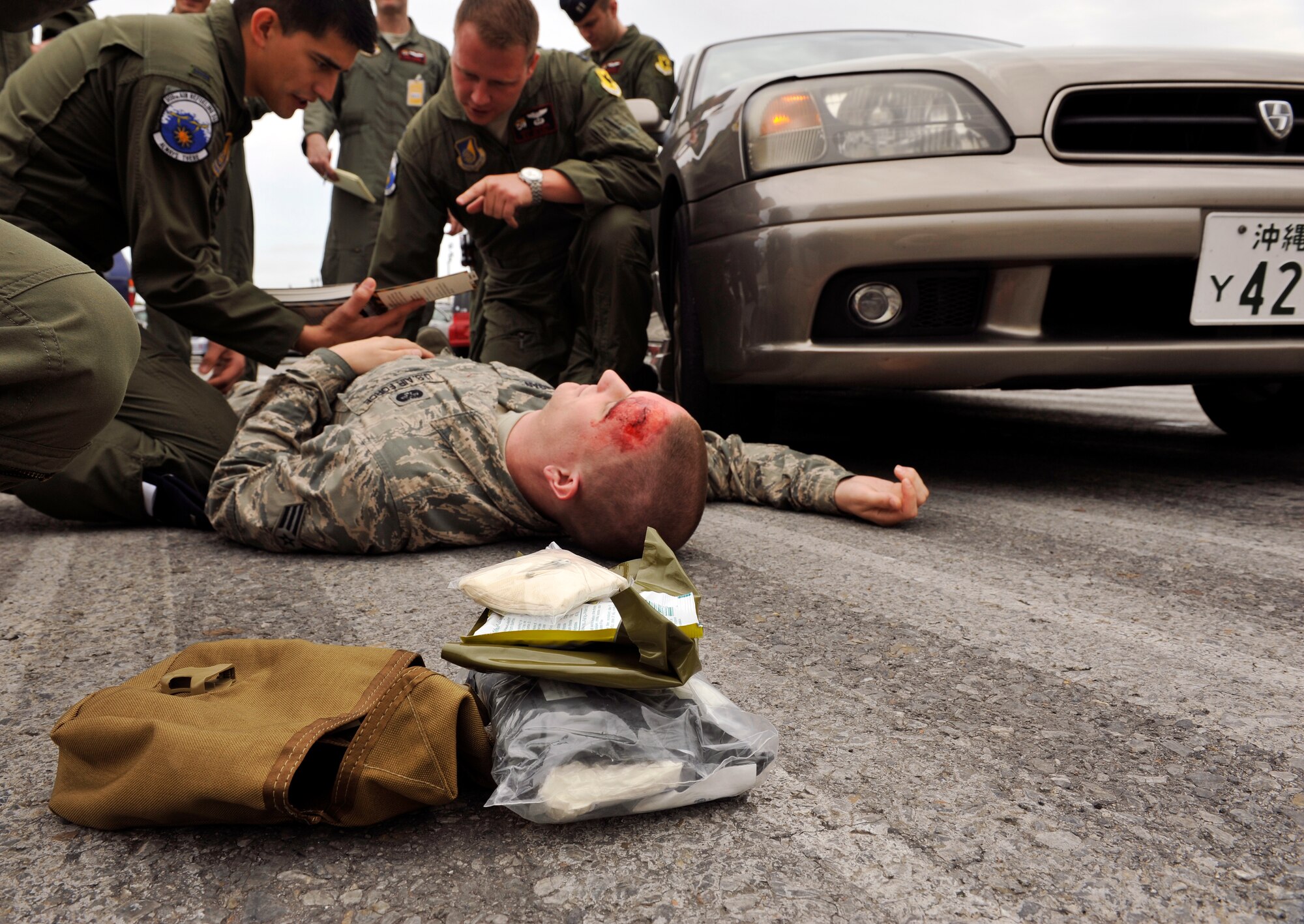 Members from the 909th Air Refueling Squadron provide self-aid and buddy care to a simulated patient during a Mission Focused Exercise scenario on Kadena Air Base, Japan, Jan. 27, 2014. Airmen are encouraged to use the Airman's Manual to find the proper procedures to help them through any situation. (U.S. Air Force photo by Naoto Anazawa)