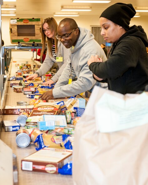 Airman 1st Class Falena Guerra, Tech. Sgt. Kevin Campbell and Staff Sgt. Maryam Johnson sort food while volunteering with the African American Heritage Council at the Second Harvest Food Bank in Spokane, Wash., Jan. 24, 2014. Second Harvest’s mission is fighting hunger and feeding hope by bringing community resources together to feed people in need through empowerment, education and partnerships. Guerra is a 92nd Logistics Readiness Squadron material management specialist, Campbell is the 92nd LRS mission capable NCO in charge, and Johnson is a 92nd Operations Support Squadron aircrew flight equipment craftsman. (U.S. Air Force photo by Staff Sgt. Benjamin W. Stratton/Released)