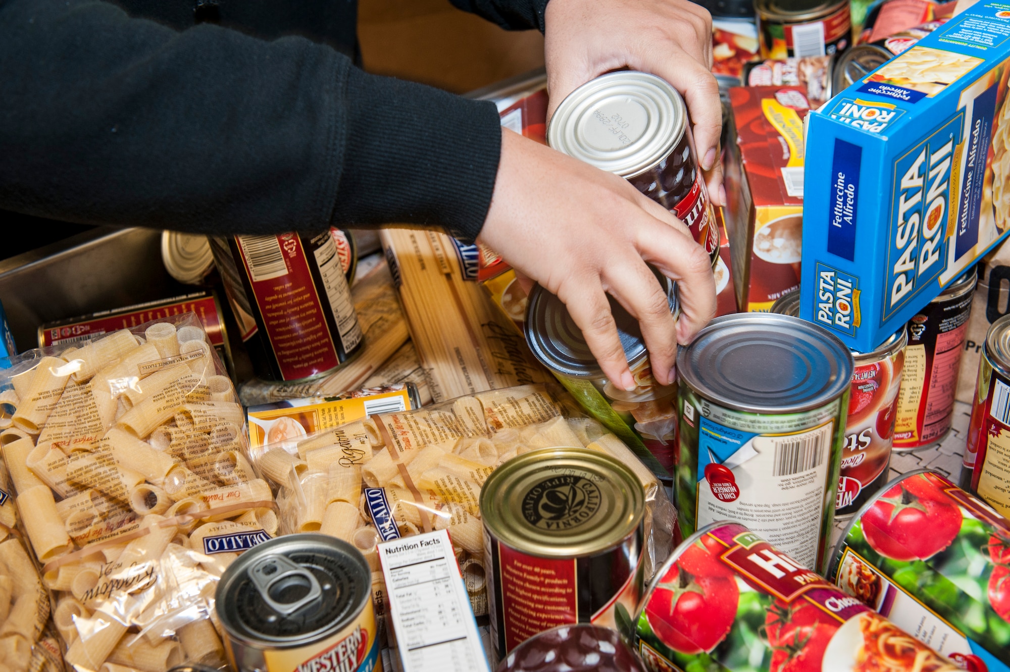 Airmen volunteering with the African American Heritage Council sort donated food while serving at the Second Harvest Food Bank in Spokane, Wash., Jan. 24, 2014. Second Harvest’s mission is fighting hunger and feeding hope by bringing community resources together to feed people in need through empowerment, education and partnerships. (U.S. Air Force photo by Staff Sgt. Benjamin W. Stratton/Released)