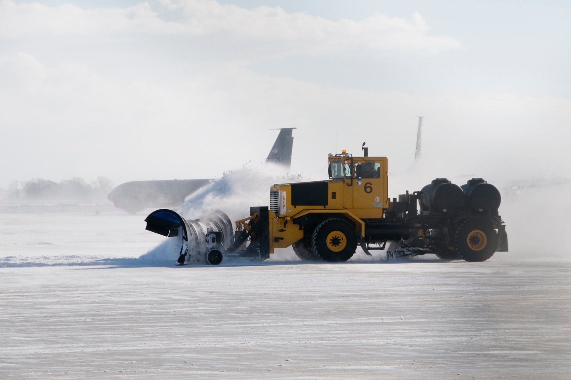 Buck Worland, a civilian contractor, uses a straight-blade plow to push snow from an airfield at Grissom Air Reserve Base, Ind., Jan. 25, 2014. Grissom's snow-control team has cleared more than 30 inches of snow that have fallen on the base's flightline this month. (U.S. Air Force photo/Staff Sgt. Andrew McLaughlin)
