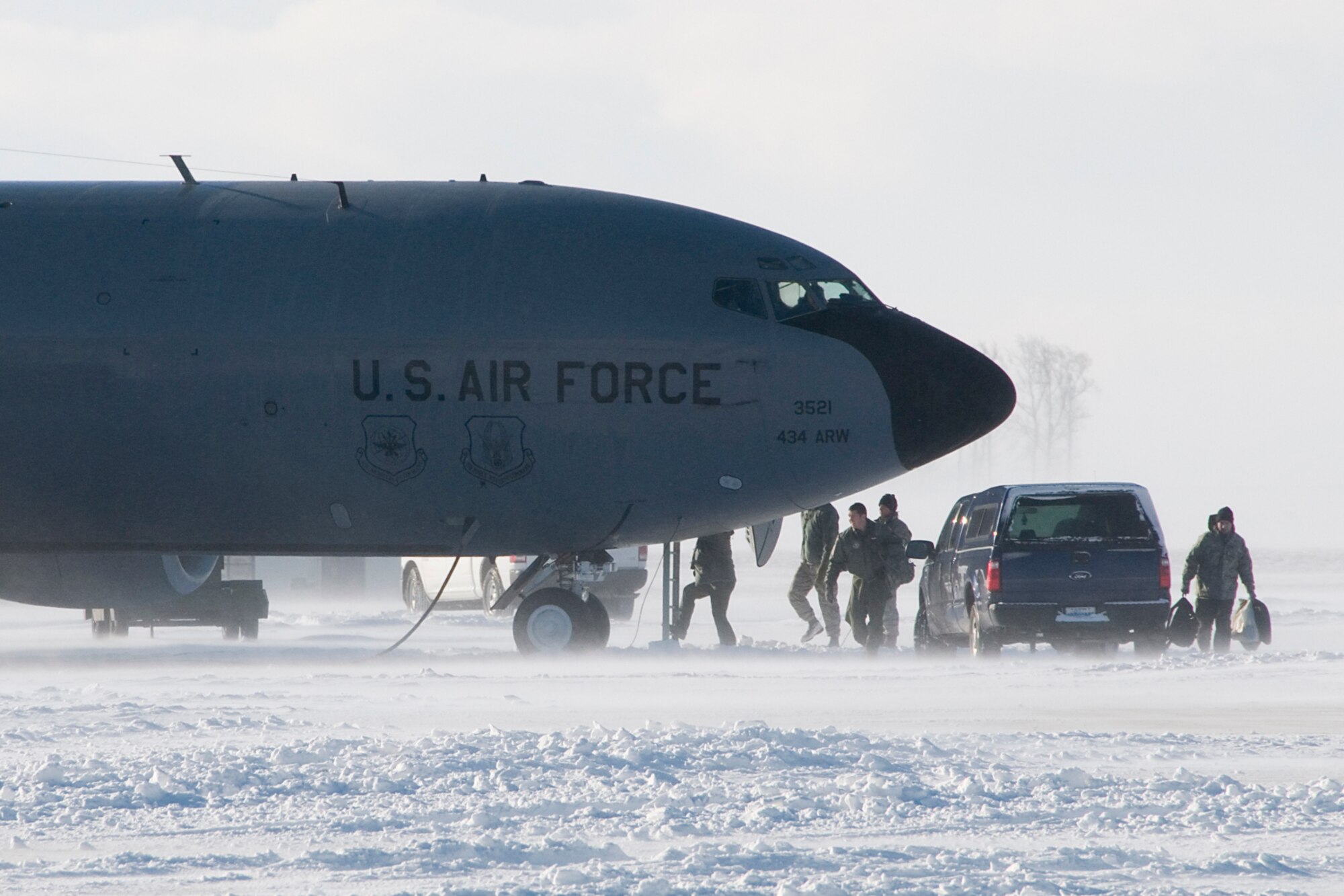 An aircrew prepares to board a KC-135R Stratotanker at Grissom Air Reserve Base, Ind., Jan. 25, 2014. After historic January snowfalls, civilian contractors have had to work hard to clear snow from Grissom's flightline so aircraft could continue to take off. (U.S. Air Force photo/Staff Sgt. Andrew McLaughlin)
