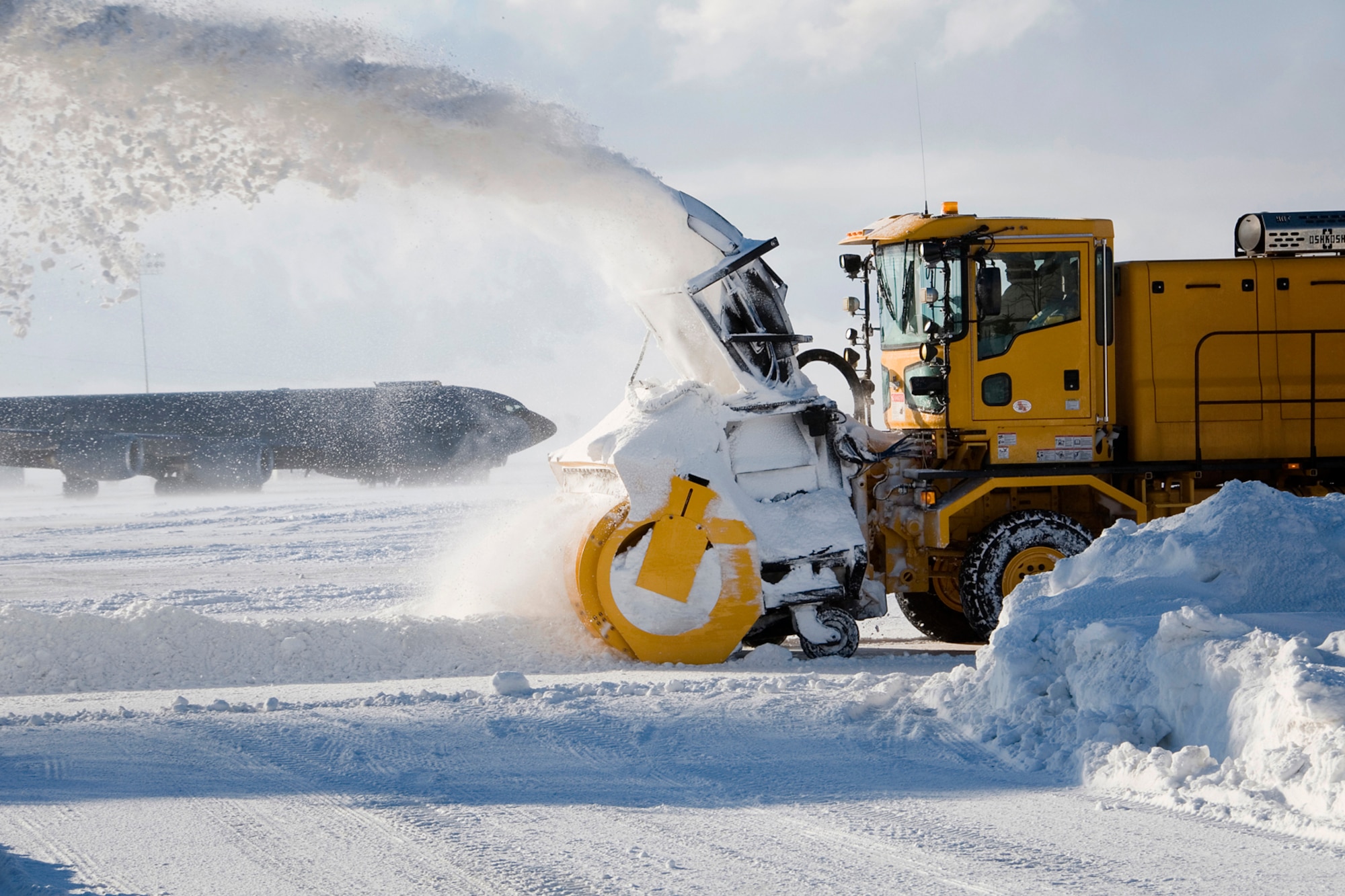 Dave Smith, a civilian contractor, removes snow from an airfield using an industrial snow blower at Grissom Air Reserve Base, Ind., Jan. 25, 2014. The base snow-control team has cleared more than 30 inches of snow that have fallen on Grissom's flightline this month. (U.S. Air Force photo/Staff Sgt. Andrew McLaughlin)
