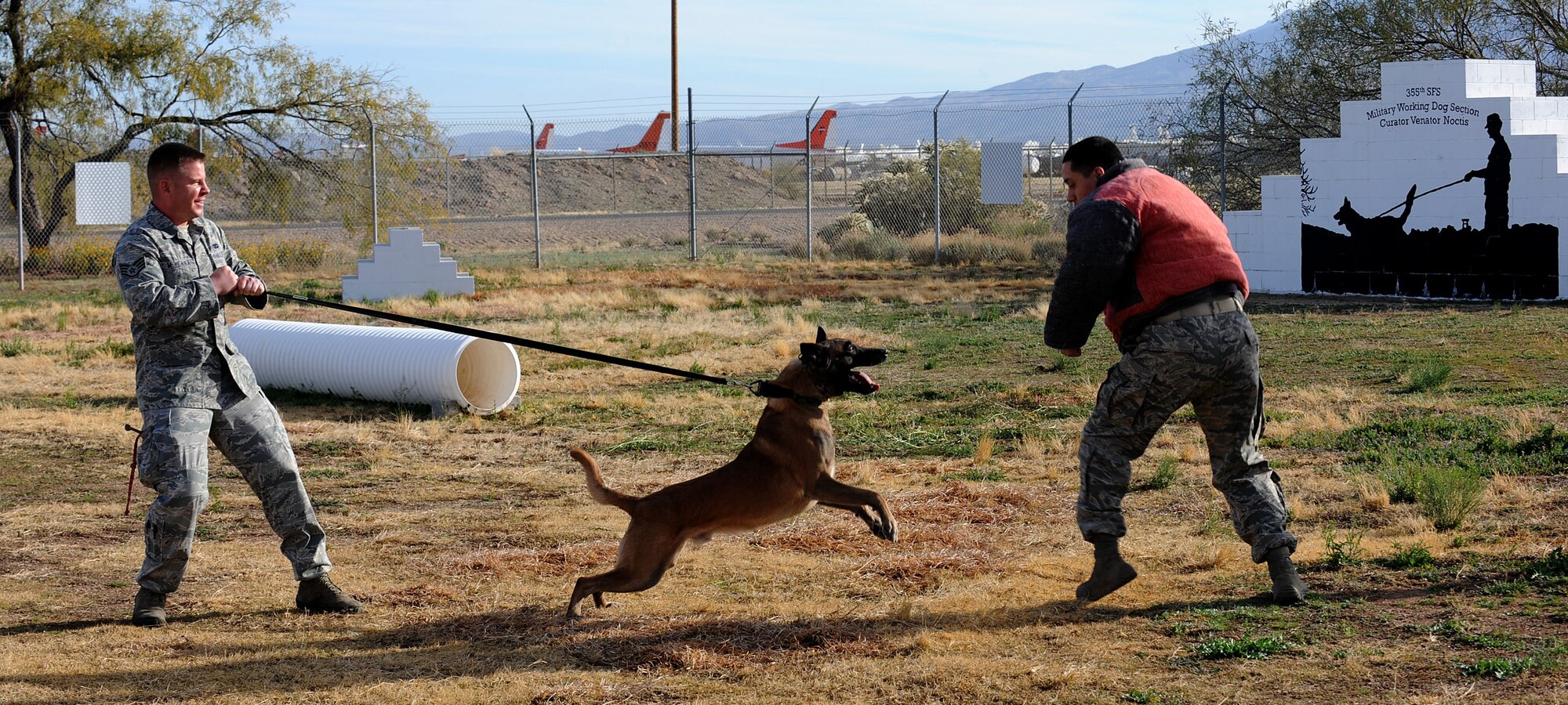 U.S. Air Force Staff Sgt. Sean McKenna, 355th Security Forces Squadron Military Working Dog handler, and Mushe, 355th SFS MWD, practice commands during obedience training at Davis-Monthan Air Force Base, Ariz., Jan. 23, 2014. McKenna is preparing for his first deployment as a MWD handler and Mushe is preparing for his third deployment. (U.S. Air Force photo by Senior Airman Camilla Elizeu/Released)