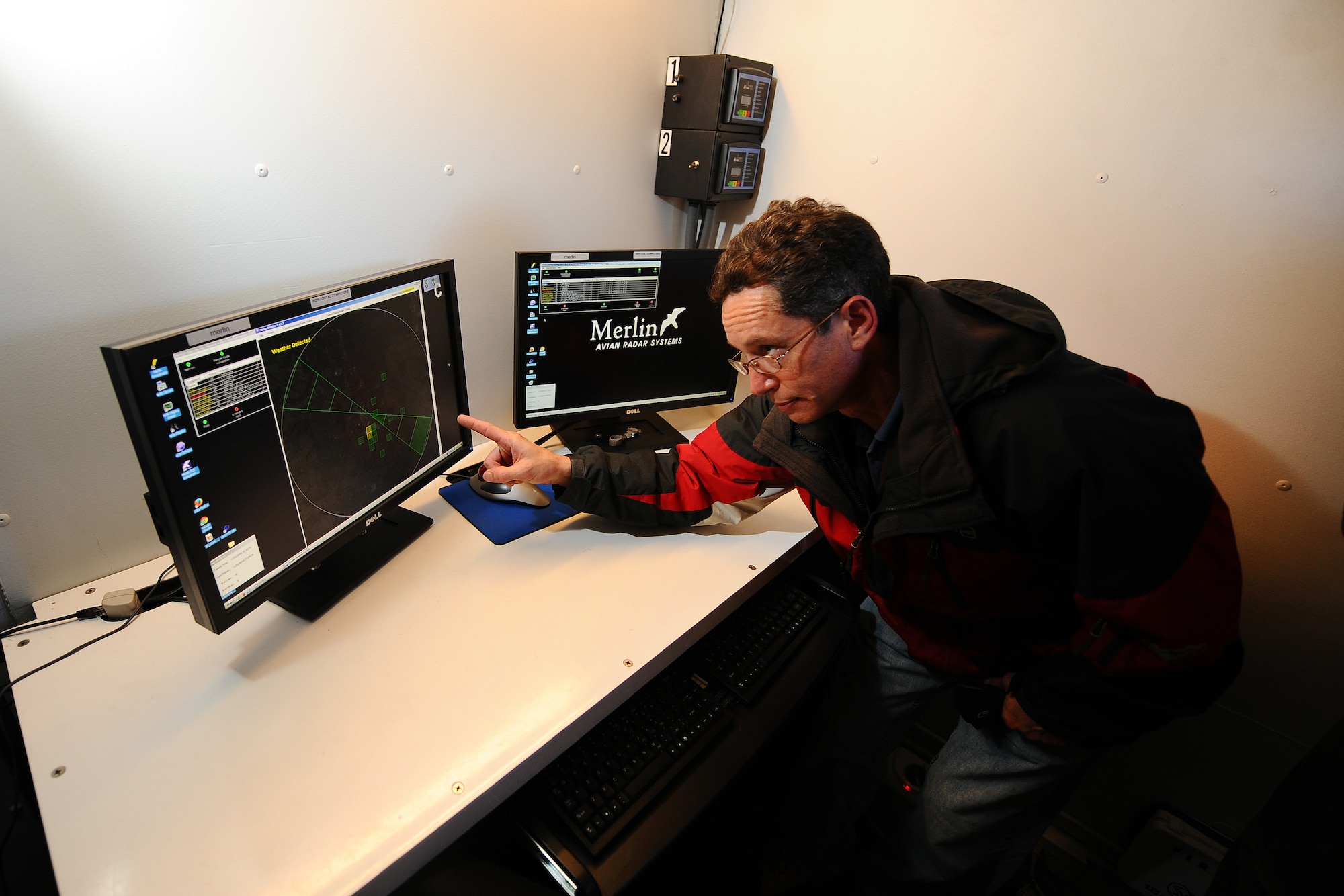 Shane Brister, a Radar Ornithologist with DeTect Inc., reboots the avian radar system from within the radar trailer parked on the north side of the base runway Jan 23, Offutt Air Force Base, Neb. Offutt has replaced its old bird detection radar with the latest radar system that compiles data in a more efficient manner allowing for real time operational responses to birds migrations around the Offutt runway. (U.S. Air Force photo by Josh Plueger/Released)  