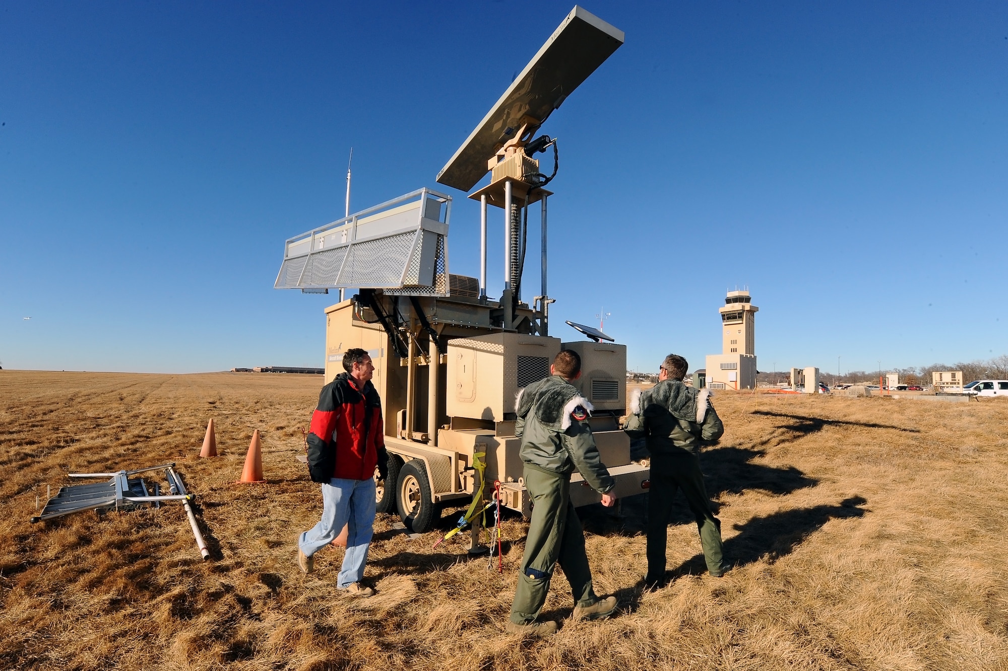 Shane Brister, a Radar Ornithologist with DeTect Inc., gives a tour of the new bird detection radar system to Maj. Dan Converse and Lt. Col Alex Bruzzano, of the 55th Wing’s Safety Office, Jan. 23, Offutt Air Force Base, Neb. The new radar allows the Flight Safety office to share the data from the radar in real time with the flight tower personnel. Offutt is the third Air Force Base to receive the new radar and is the first in the Department of Defense to be able to share the data simultaneously with the flight tower staff.  U.S. Air Force photo by Josh Plueger/Released)  