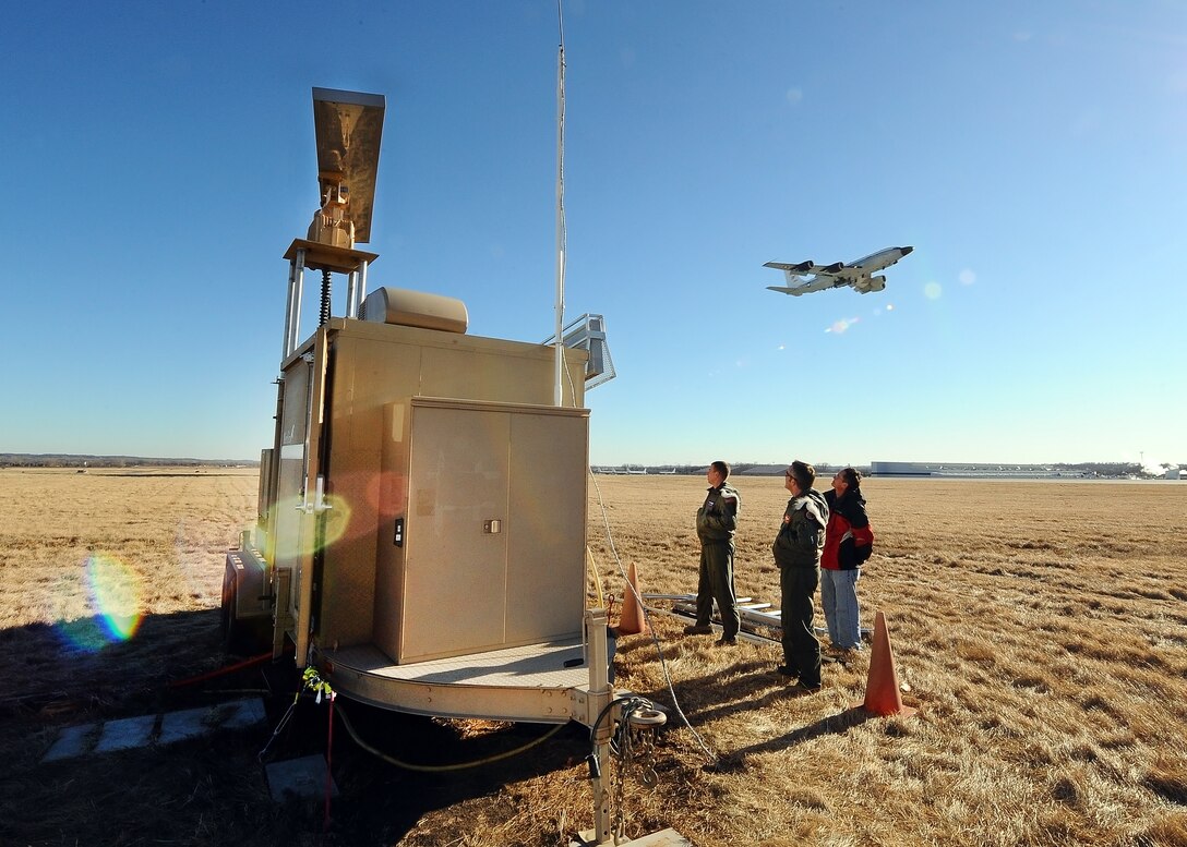 Airmen assigned to the 55th Wing’s Flight Safety office tour the new Merlin Radar as an RC-135S Cobra Ball takes flight on the base runway Jan. 23, Offutt Air Force Base, Neb. The newly acquired radar is used to detect birds within a four-mile radius both horizontally and vertically in order to prevent bird collisions with Offutt’s aircrafts. (U.S. Air Force photo by Josh Plueger/Released)  