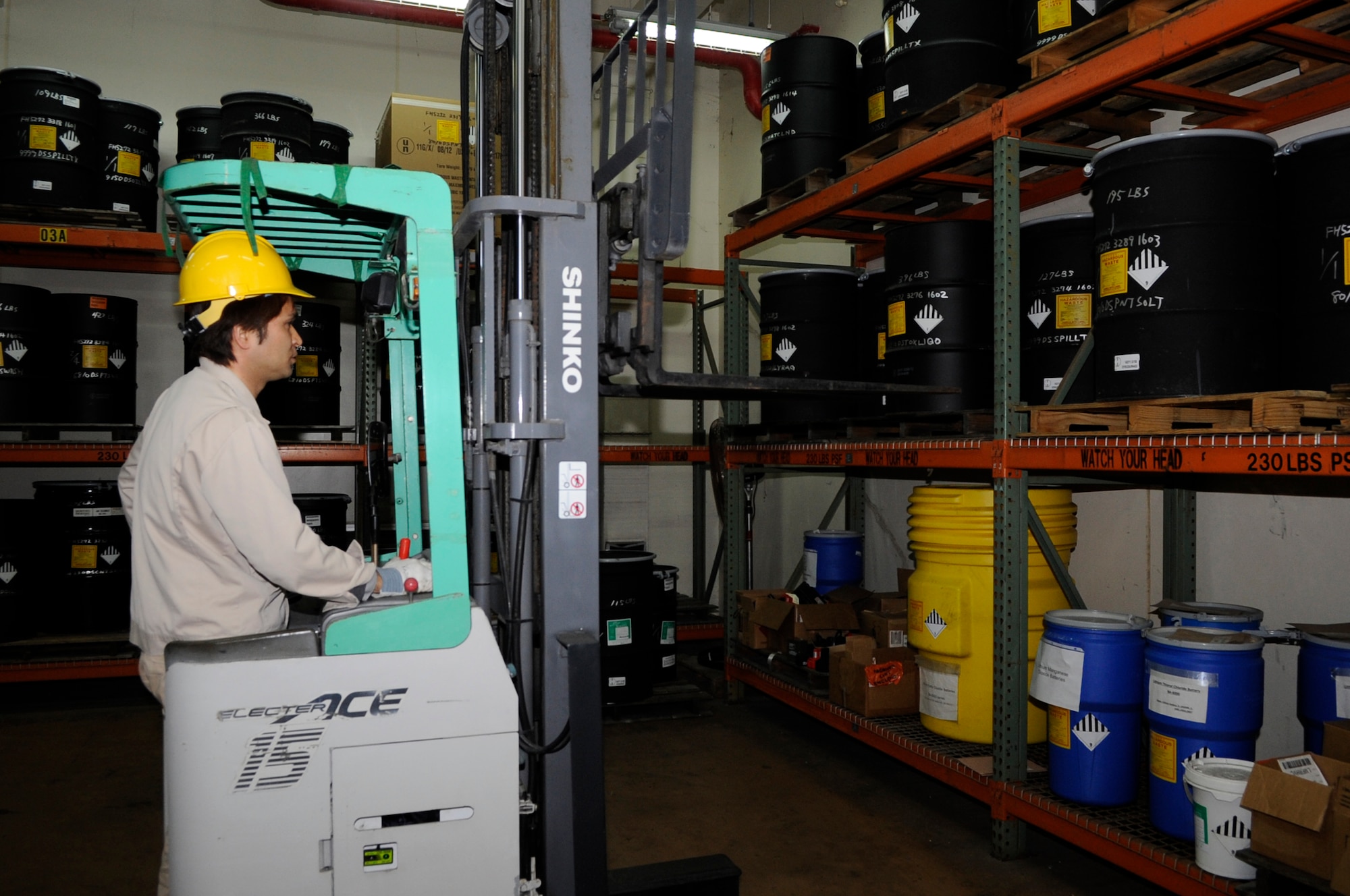 Kazuhiko Afuso, 718th Civil Engineer Squadron hazardous waste storage technician, uses a fork lift to move hazardous waste containers onto pallets for pick-up on Kadena Air Base, Japan, Jan. 22, 2014. The Hazardous Waste Flight is in charge of inspecting and regulating more than 150 hazardous waste accumulation points and works with approximately 550 site managers from Air Force, Army and Navy personnel, as well as Japanese nationals. (U.S. Air Force photo by Senior Airman Marcus Morris)