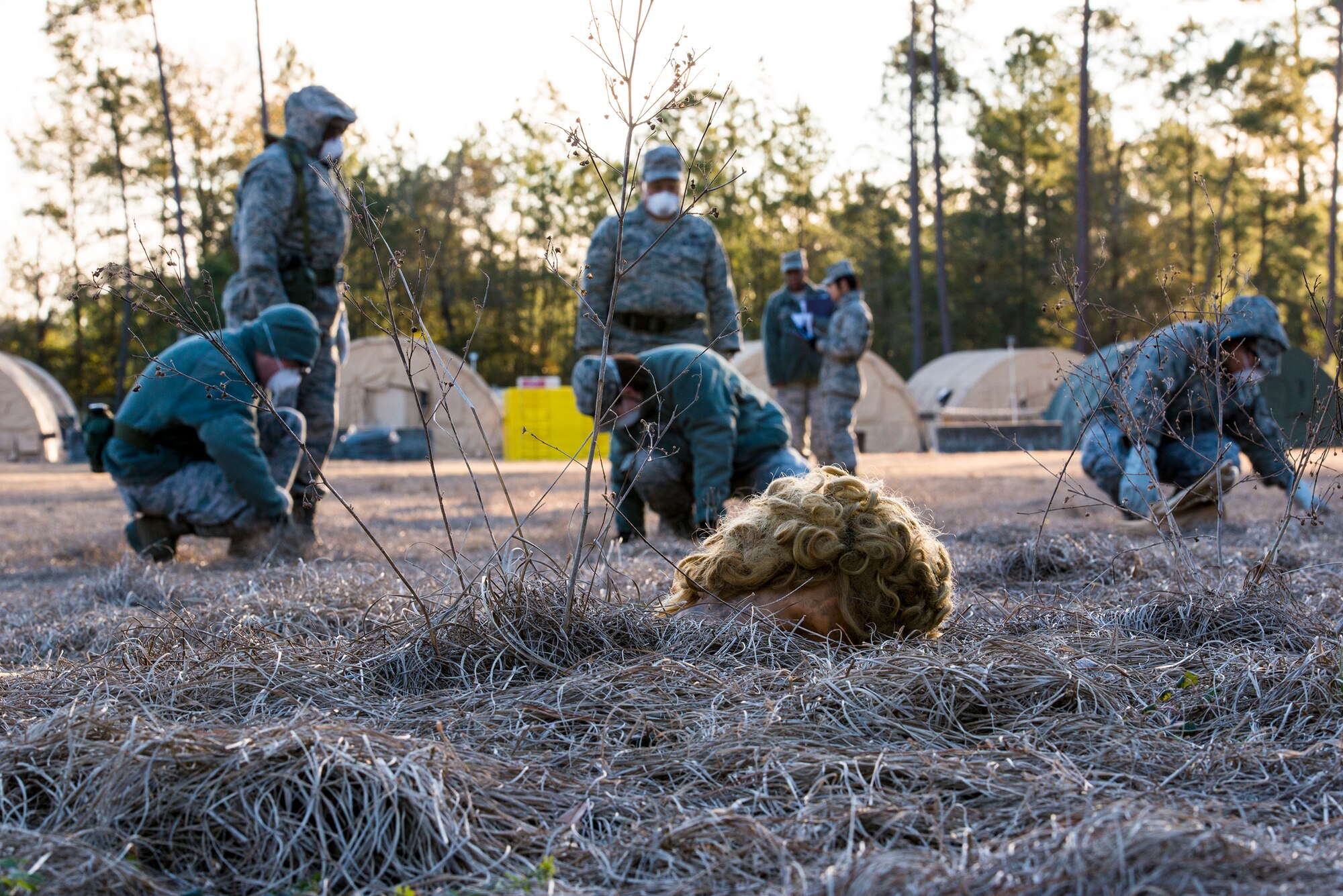 U.S. Air Force Airmen from Moody’s search and recovery team search the ground for foreign objects during a SART exercise at Moody Air Force Base, Ga., Jan. 24, 2014. A SART is dispatched after a mass casualty event to identify remains and personal affects. The SART forms a line and sweeps the entire scene in order to conduct an organized, comprehensive search. (U.S. Air Force photo by Airman 1st Class Ryan Callaghan/Released)
