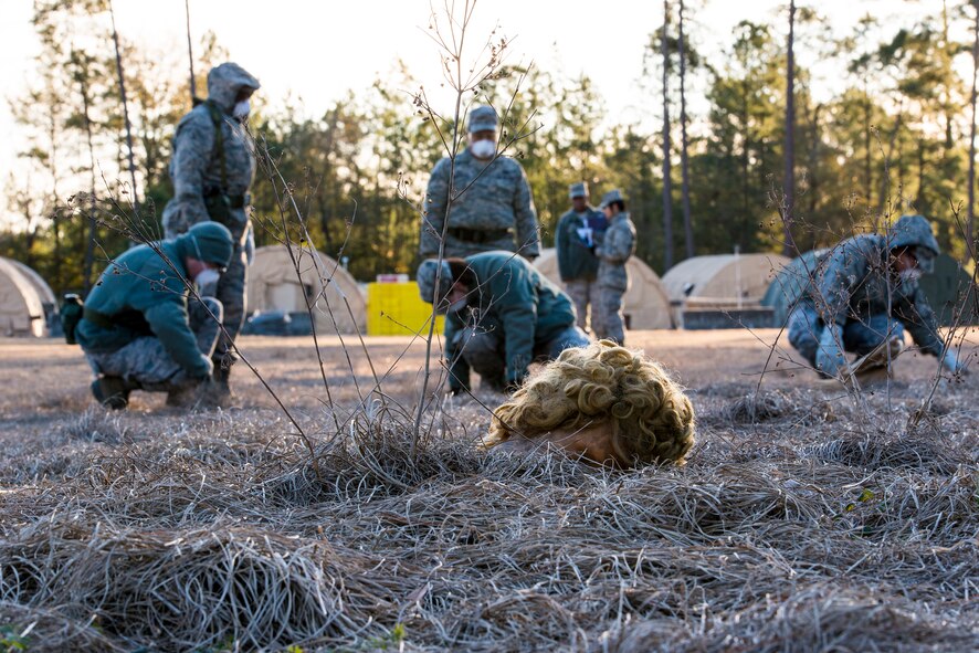 U.S. Air Force Airmen from Moody’s search and recovery team search the ground for foreign objects during a SART exercise at Moody Air Force Base, Ga., Jan. 24, 2014. A SART is dispatched after a mass casualty event to identify remains and personal affects. The SART forms a line and sweeps the entire scene in order to conduct an organized, comprehensive search. (U.S. Air Force photo by Airman 1st Class Ryan Callaghan/Released)
