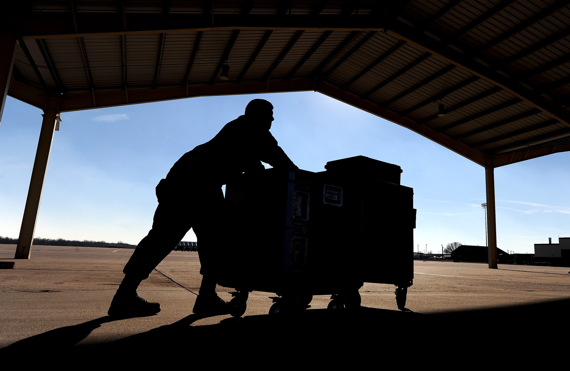 Airman 1st Class Cameron Wheatley, 442nd Fighter Wing Aircraft Maintenance Squadron aircraft armament technician, pushes a 500-pound toolbox to an aircraft at Whiteman Air Force Base, Mo., Dec. 17, 2013. The toolbox contains every instrument necessary for Wheatley to load any type of weapon system onto an A-10 Thunderbolt II. (U.S. Air Force photo by Staff Sgt. Nick Wilson/Released)
