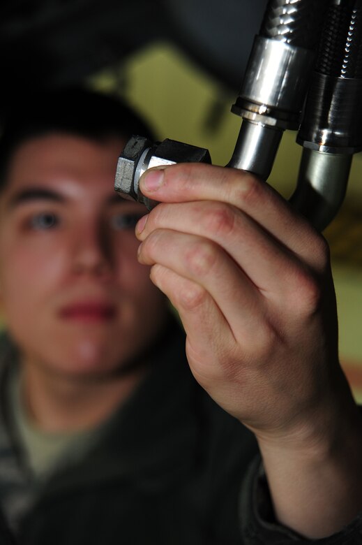 Airman 1st Class Cameron Wheatley, 442nd Fighter Wing Aircraft Maintenance Squadron aircraft armament technician, inspects the hydraulic lines of an A-10 Thunderbolt II gun bay at Whiteman Air Force Base, Mo., Dec. 17, 2013. While performing the inspection Wheatley is looking for leaks and damage to the hydraulic line. (U.S. Air Force photo by Staff Sgt. Nick Wilson/Released)