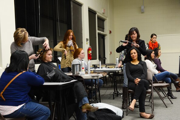 Spouses of deployed Airmen get their hair done at a Hearts Apart event on Shaw Air Force Base, S.C., Jan. 24, 2014. Volunteers came to the event to glamourize the mothers for the photos they will be sending to their spouses overseas on Valentine’s Day. (U.S. Air Force photo by Airman 1st Class Diana M. Cossaboom/Released) 