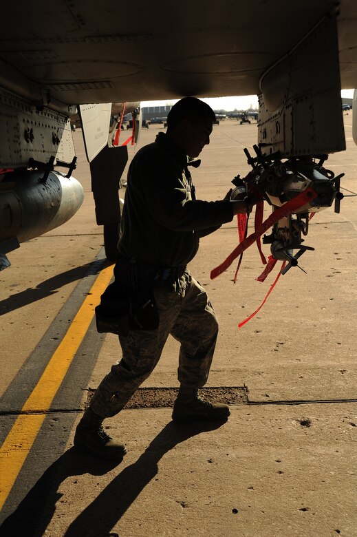 Airman 1st Class Cameron Wheatley, 442nd Fighter Wing Aircraft Maintenance Squadron aircraft armament technician, verifies that pins are installed on the weapons array of an A-10 Thunderbolt II on the flightline at Whiteman Air Force Base, Mo., Dec. 17, 2013. This is part of a routine inspection that Wheatley is responsible for conducting each day. (U.S. Air Force photo by Staff Sgt. Nick Wilson/Released)