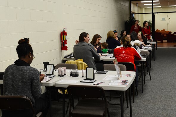 Spouses of deployed Airmen gather at the make-up tables during a Hearts Apart event at Shaw Air Force Base, S.C., Jan. 24, 2014. The mothers came to the event hosted by the Airman and Family Readiness Center to get glamour shots taken for Valentine’s Day, to send to their spouses overseas. (U.S. Air Force photo by Airman 1st Class Diana M. Cossaboom/Released) 