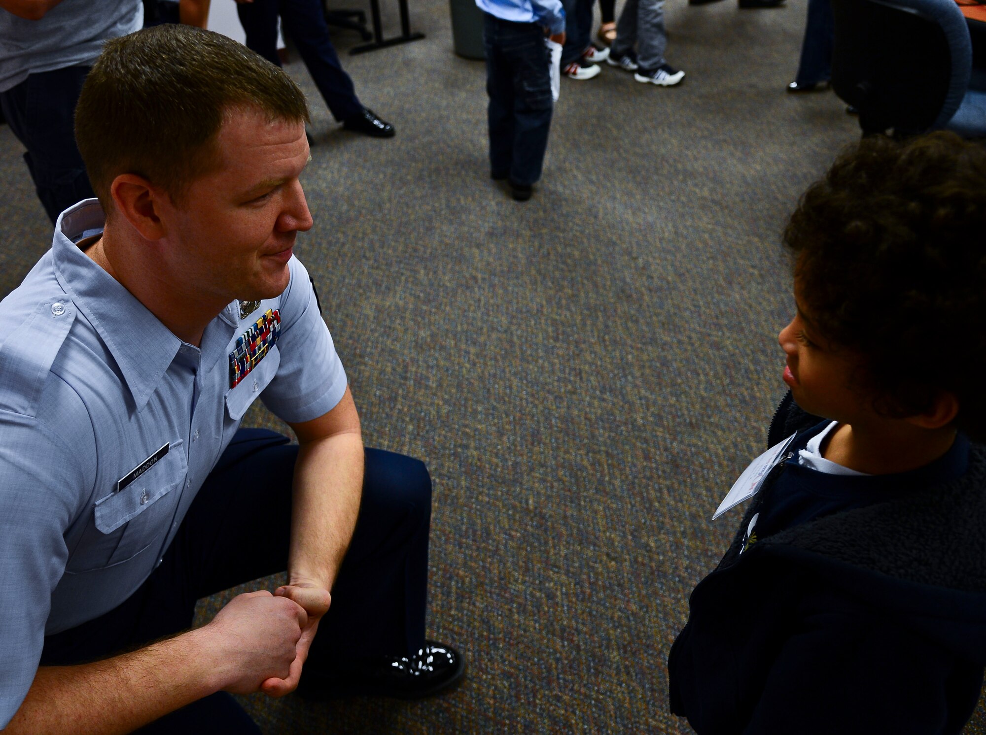 Tech Sgt. George Maddon, 6th Air Mobility Wing public affairs broadcaster, talks to Trent, a Lincoln Magnet Elementary School student, at the “Read on myON” Hillsborough County Public Schools awards breakfast Jan. 27, 2014. Seventeen children, ranging from preschool to fifth grade, were chosen as winners. (U.S. Air Force photo by Airman 1st Class Vernon L. Fowler Jr./Released)