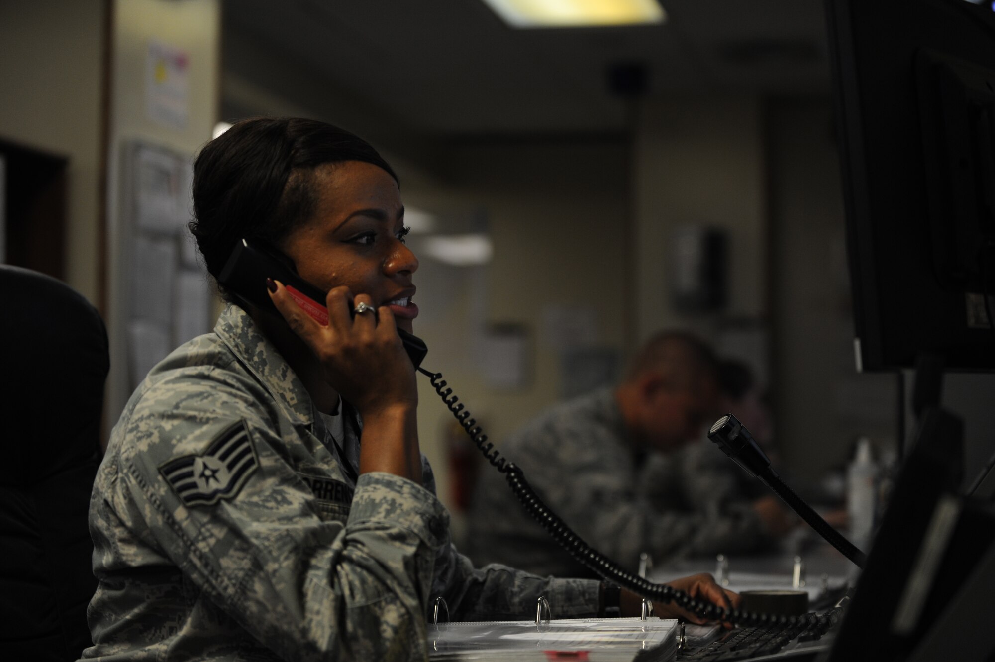 U.S. Air Force Staff Sgt. Brittany Torrence, 18th Command Post senior emergency actions controller, disseminates emergency information to local base agencies during a Mission Focused Exercise on Kadena Air Base, Japan, Jan. 28, 2014. By honing skills in a simulated war-time contingency environment, the 18th Wing ensures Airmen are well trained and prepared to execute their war-time mission. (U.S. Air Force photo by Airman 1st Class Keith James)