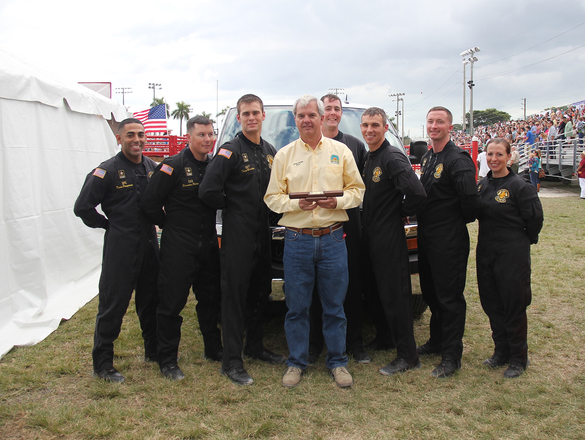 Members of the U.S. Army parachute team: The Golden Knights kicked off their 2014 air show season with a jump into the Homestead, Fla., Rodeo Jan. 25 and 26. Gold Team leader SFC Dustin Peregrin had the privilege of jumping on Saturday with the Golden Knight baton to present to Homestead Mayor Jeff Porter. The black team backed up that performance by jumping in a stellar show the following day. (U.S. Army photo)