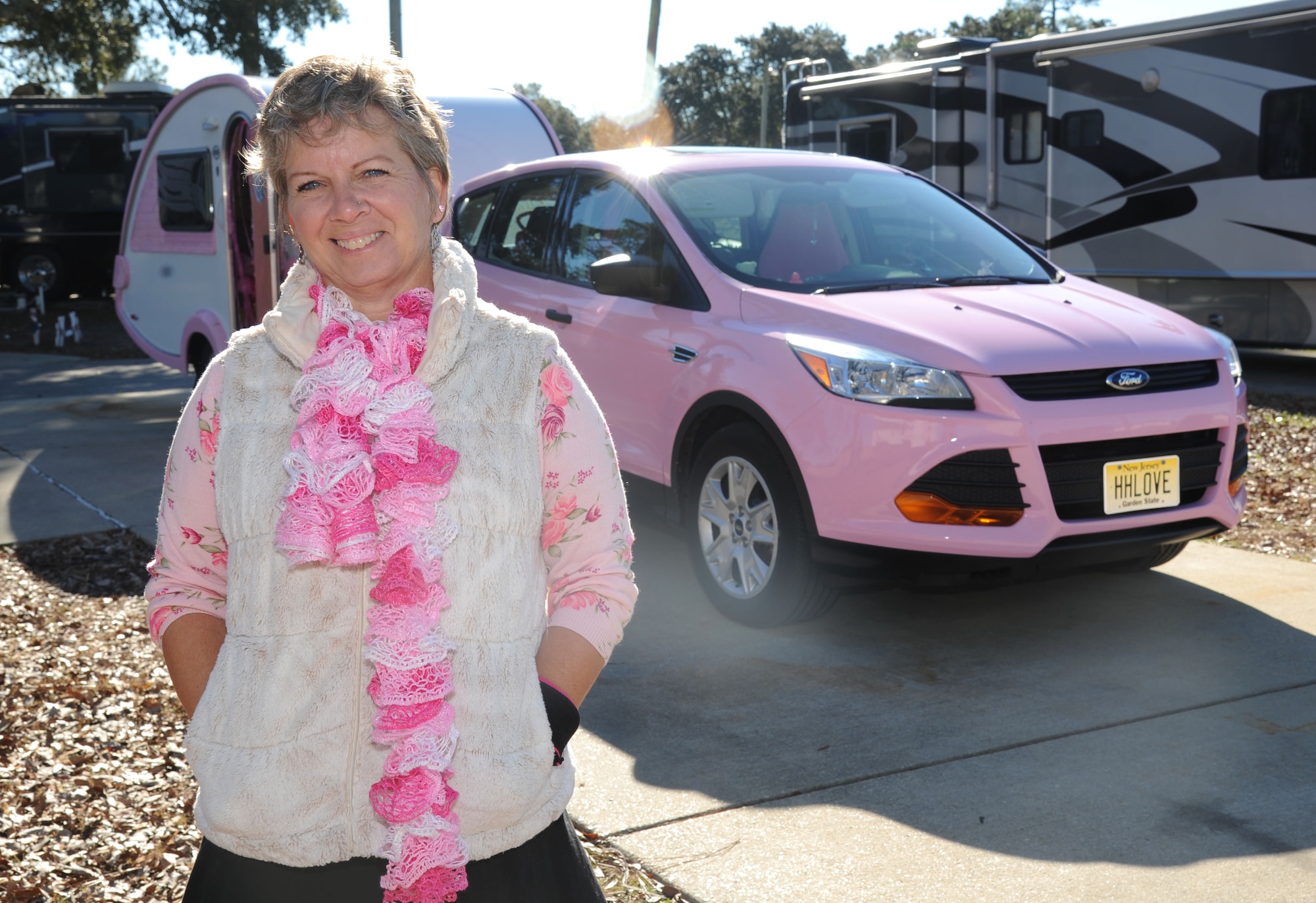 Alison Miller, widow of retired Master Sgt. Chuck Dearing, stands in front of her pink painted vehicle and teardrop trailer during a travel break Jan. 16, 2014, at the Keesler Air Force Base camp site, Biloxi, Miss. Following Dearing’s retirement, the couple sold their home and belongings and traveled the country for four years staying primarily in base lodgings. Prior to the death of her husband, Miller told him that her intent was to continue traveling in a pink painted car so that he could find her while out on the road.  (U.S. Air Force photo by Kemberly Groue)