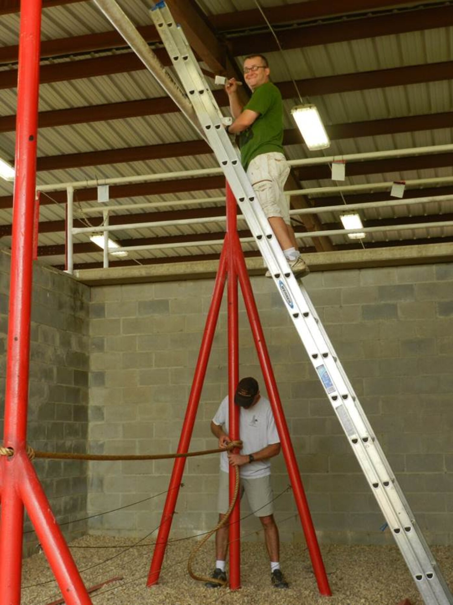 A volunteer from the  Squadron Officer College on Maxwell Air Force Base repaints part of an obstacle at the Project X leadership reaction course.  Volunteers from the faculty and staff of the SOC spent over 100 combined man hours on a Saturday refurbishing the course to ensure it remains an effective training tool for students at any one of Maxwell’s many schools. (U.S. Air Force Courtesy photo