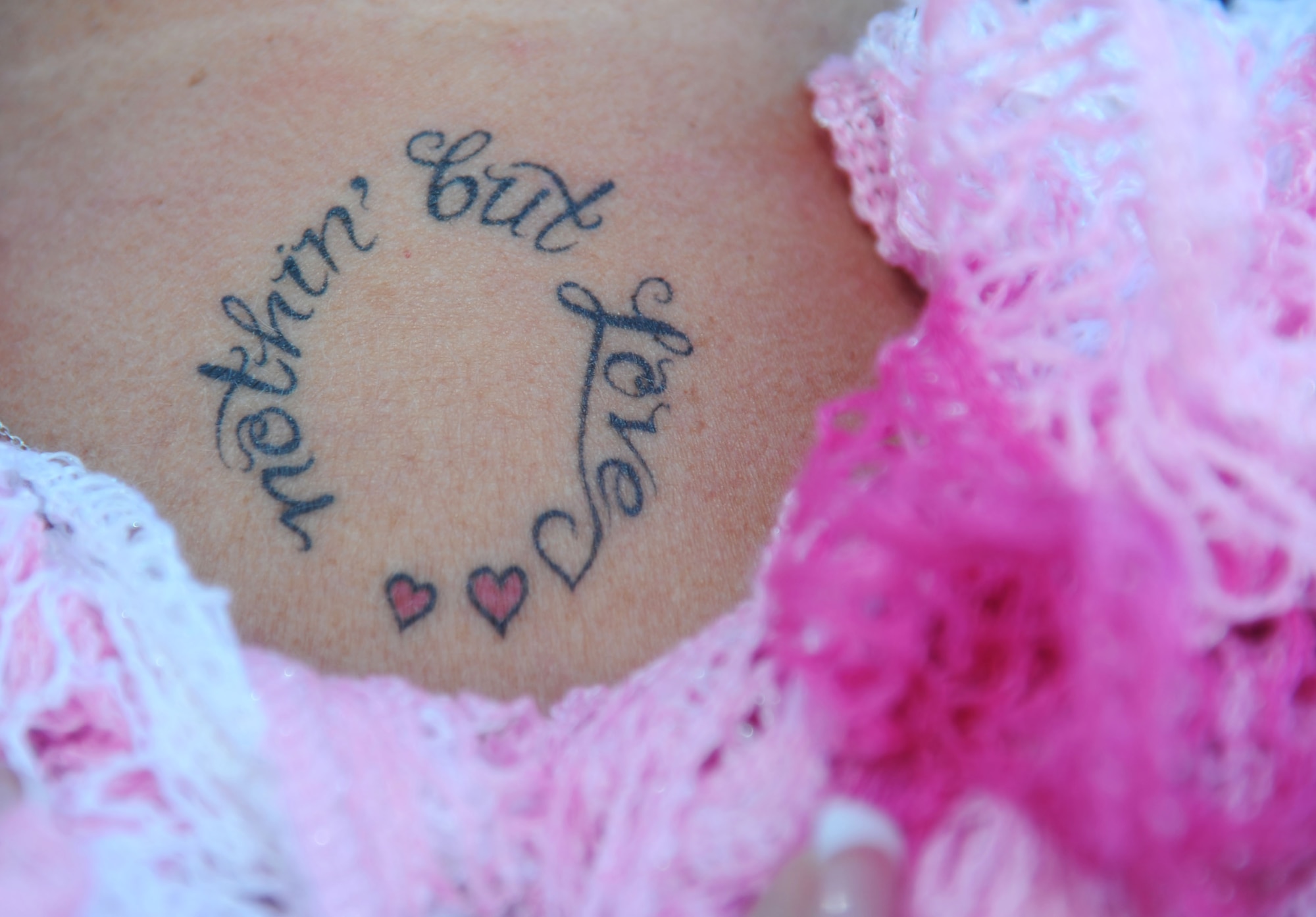 Alison Miller shows a tattoo, which she had done in memory of her late husband, retired Master Sgt. Chuck Dearing, Jan. 16, 2014, at the Keesler Air Force Base camp site, Biloxi, Miss.  Following Dearing’s retirement, the couple sold their home and belongings and traveled the country for four years staying primarily in base lodgings.  (U.S. Air Force photo by Kemberly Groue)