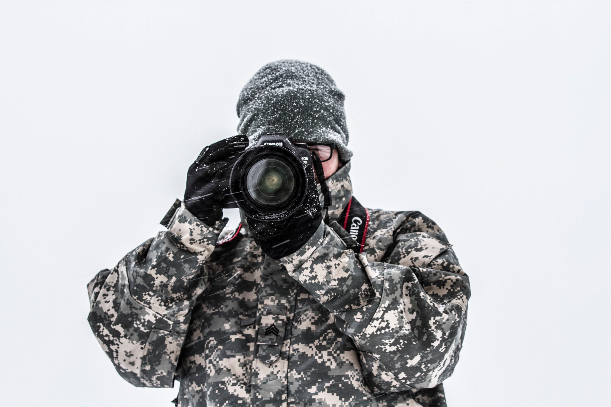 Sgt. Kenneth Tucceri with the 107th Mobile Public Affairs Detachment, St. Augustine, Fla., takes photos in the windy snow at Joint Base Mcguire-Dix-Lakehurst, N.J., Jan. 20. Tucceri, who is originally from New England, says he's much more comfortable with the snowy conditions than many in his unit, some of whom have never seen snow prior to mobilizing for their deployment to Guantanamo Bay, Cuba. (U.S. Army photo by Staff Sgt. Karen Kozub/Released)
