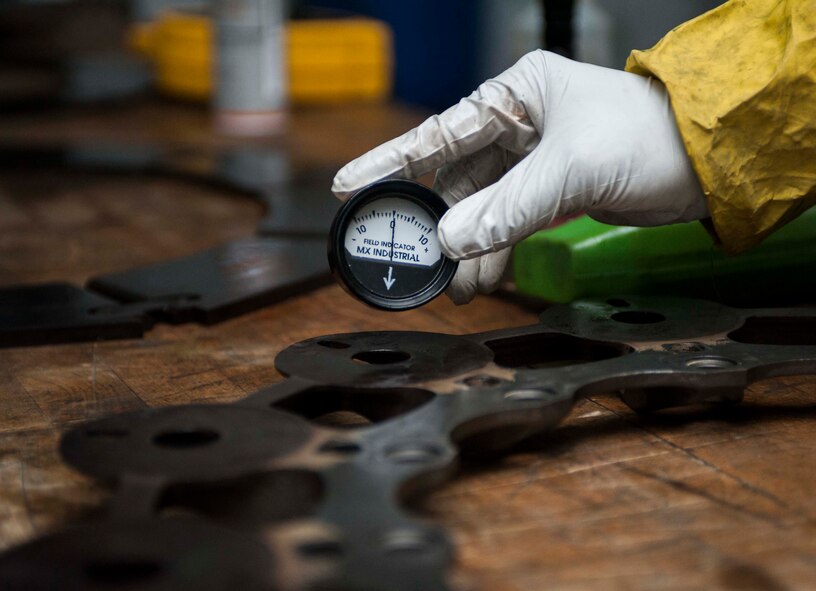 A field indicator is used to ensure the brake pads of a B-52H Stratofortress have been properly demagnetized during a Magnetic Particle Inspection at Minot Air Force Base, N.D., Jan. 21, 2014. Once a Magnetic Particle inspection has been completed, the part must be demagnetized as residual magnetization can interfere with aircraft instrumentation.  (U.S. Air Force photo/Senior Airman Stephanie Sauberan)   