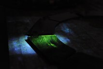 Fluorescent magnetic particles glow under black light during a Magnetic Particle Inspection on the brake pads of a B-52H Stratofortress at Minot Air Force Base, N.D., Jan. 21, 2014. The fluorescent magnetic particles used on the brake pad provide a contrast with the part and allowing identification of any flaws. (U.S. Air Force photo/Senior Airman Stephanie Sauberan)   